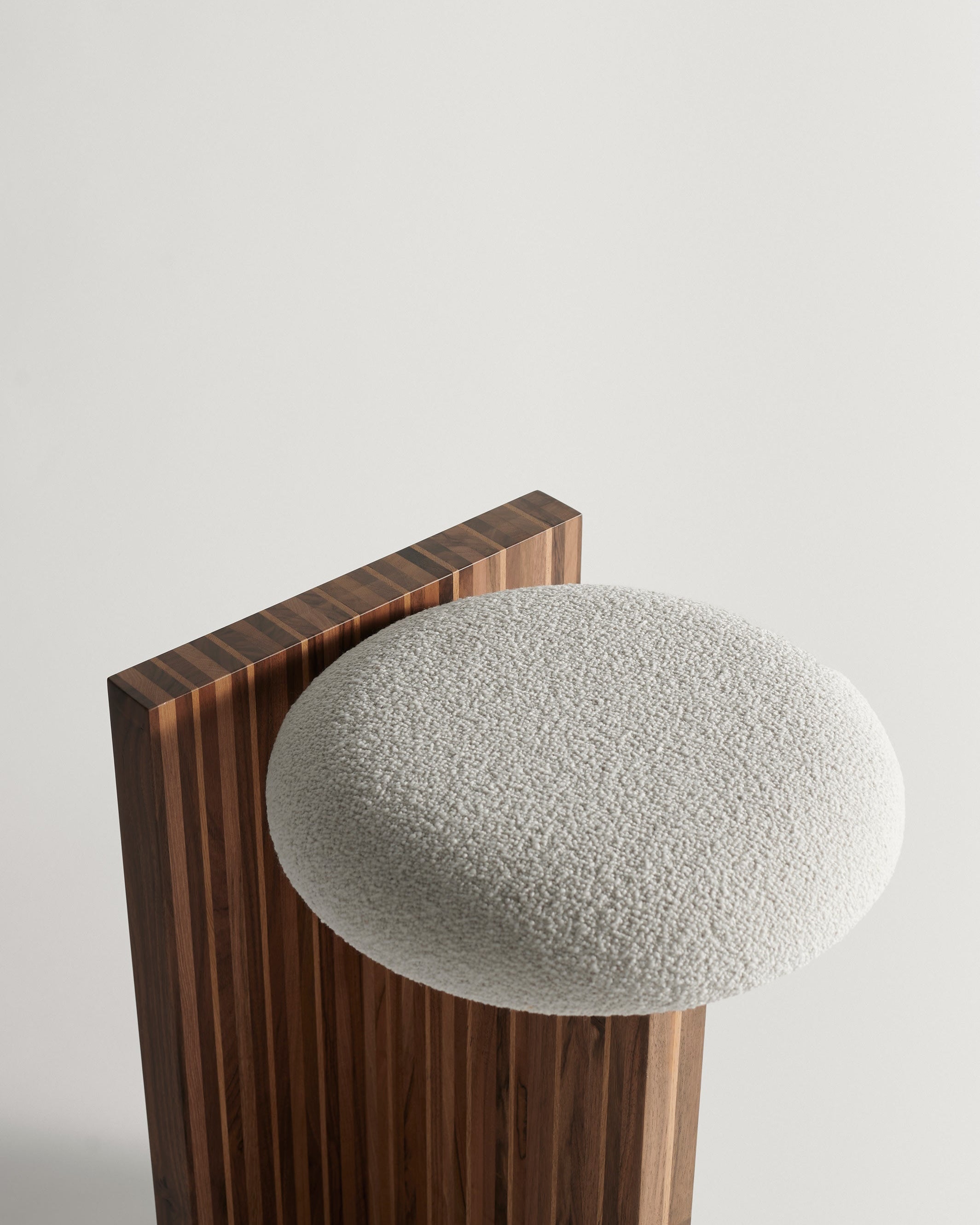Arquivo Counter Stool — top view of textured fabric seat and wooden base