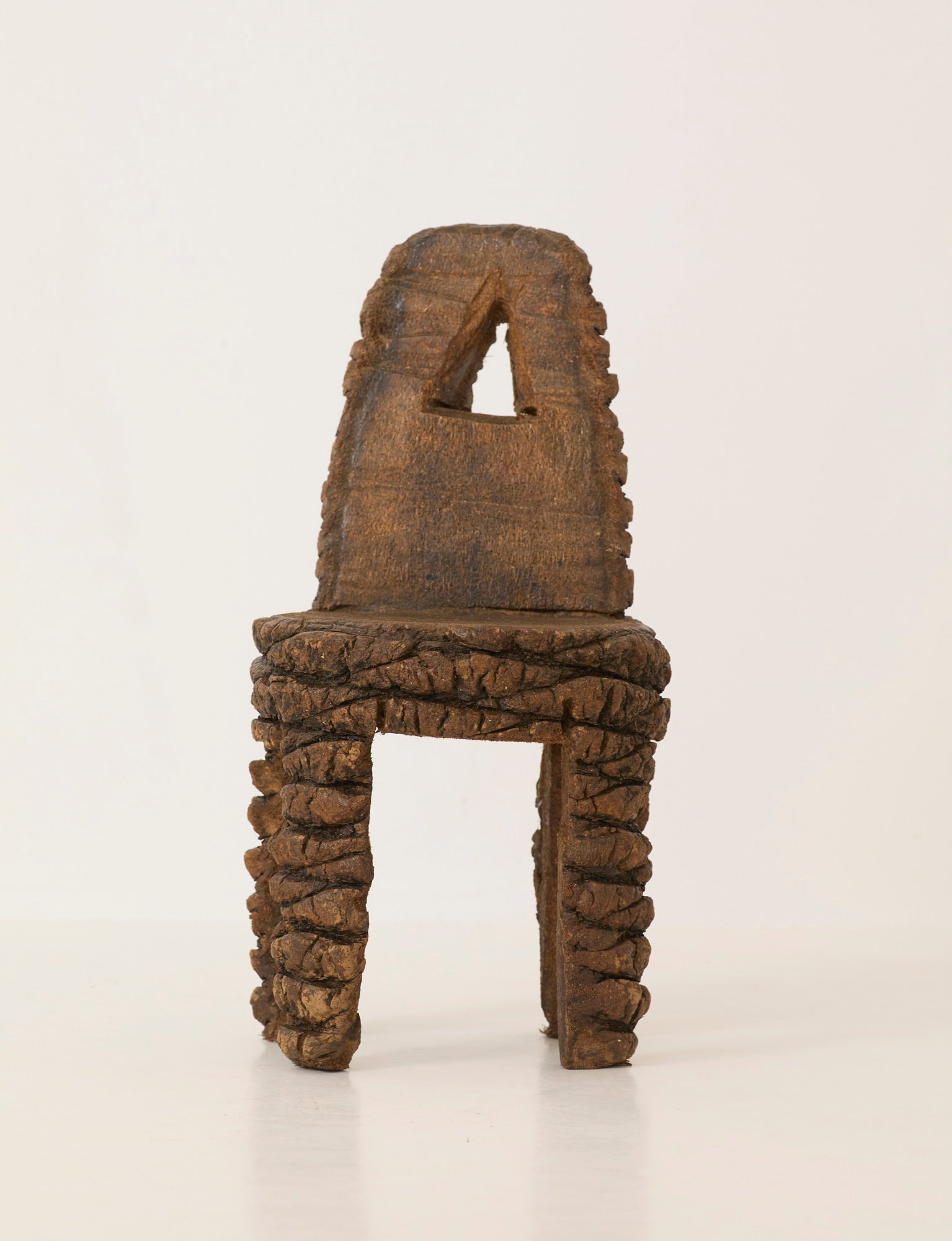 Small Artisanal Brutalist Chair in Solid Palm Tree C. 1970 — front view against neutral background
