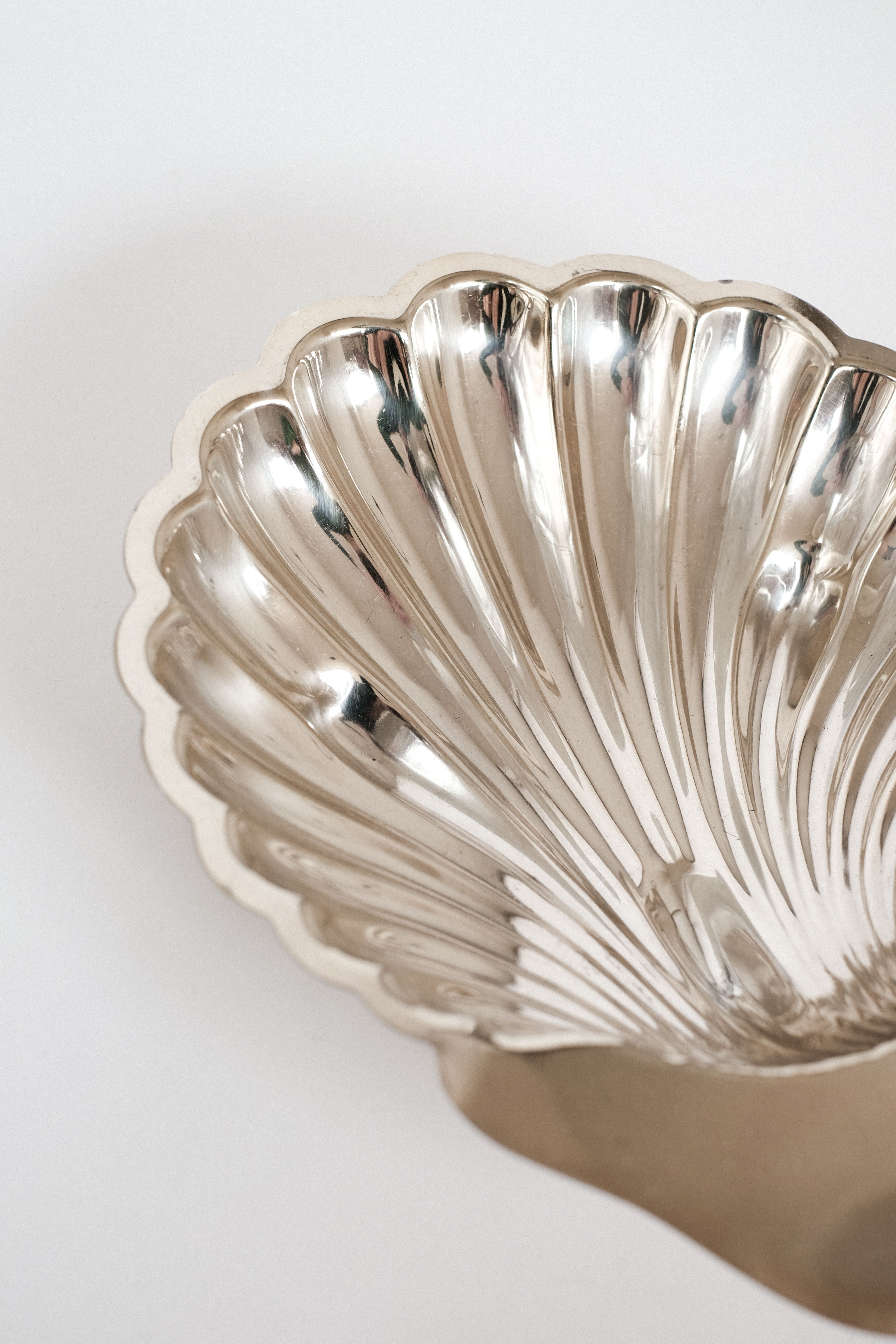 Medium Shell Shaped Vide-poches — back view of polished metal dish