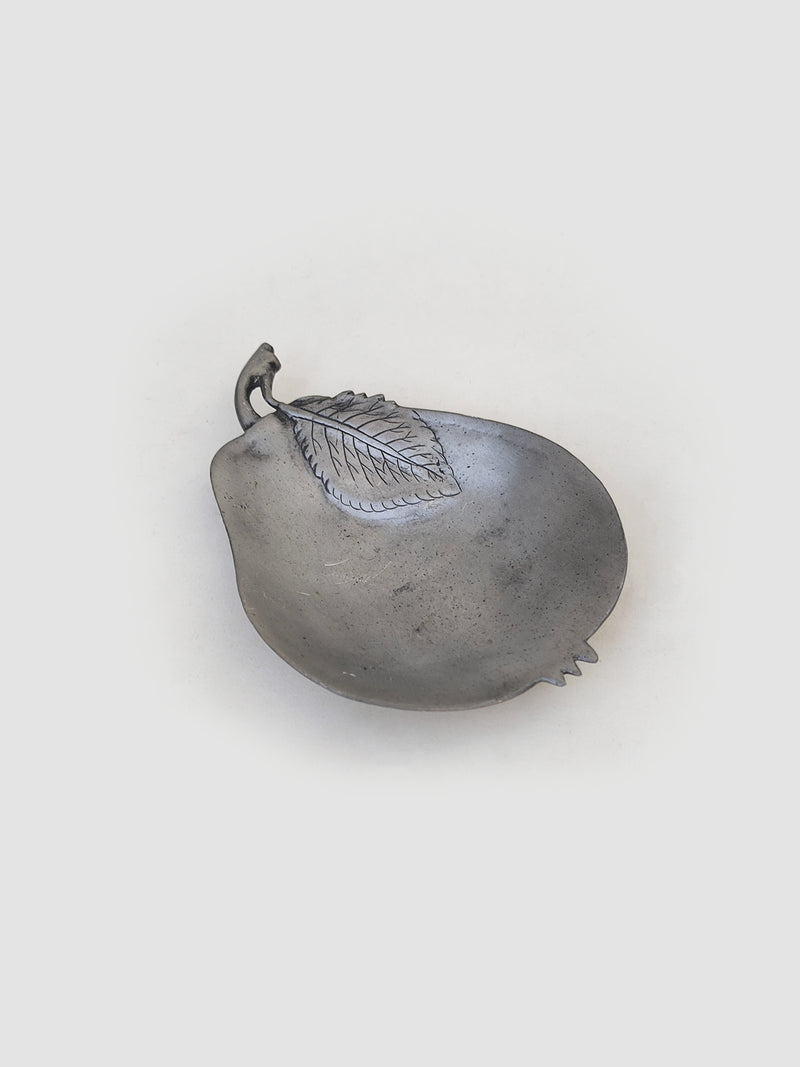 Pear pewter vide poche — close-up of pear-shaped dish with leaf detail