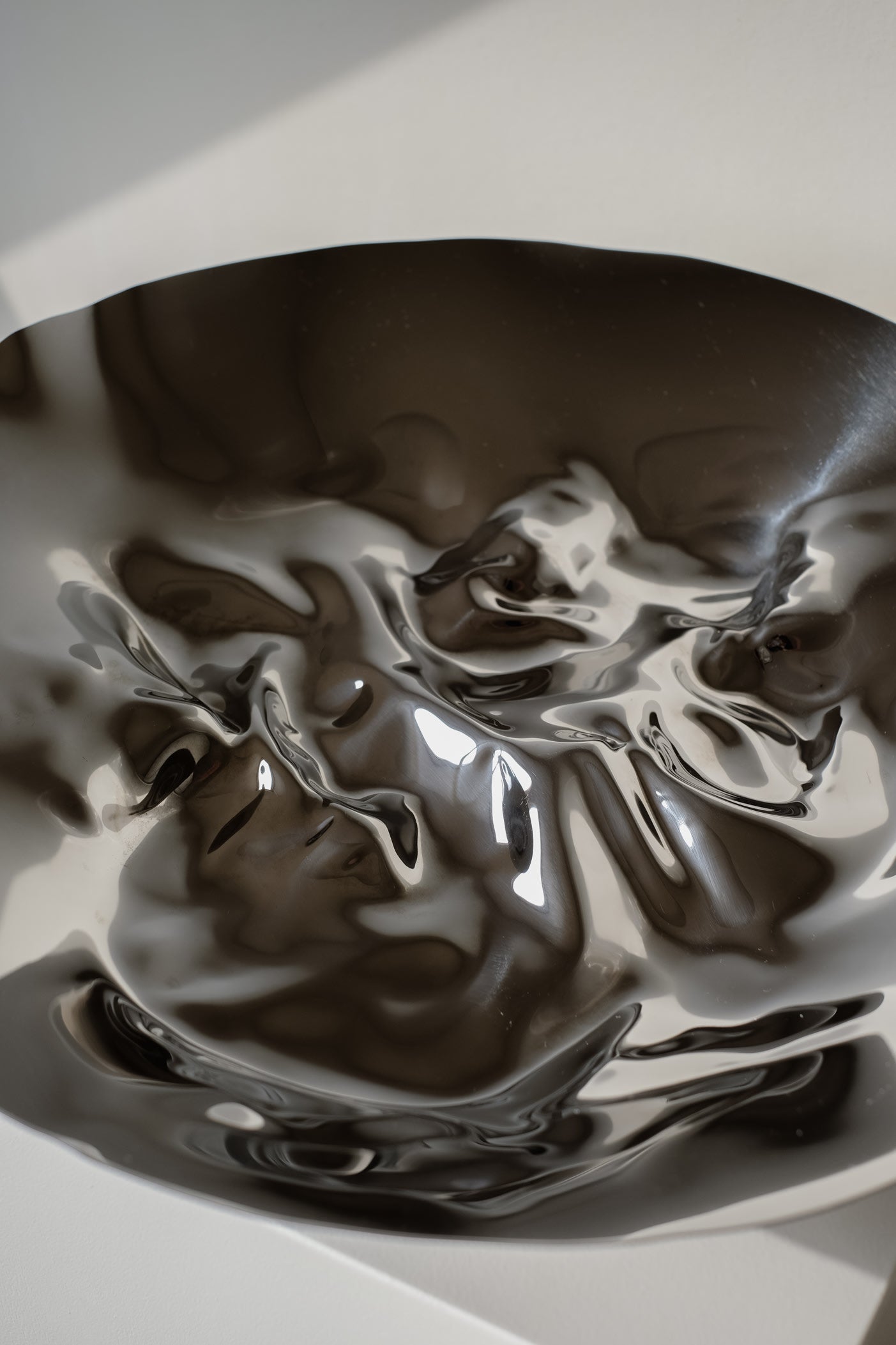 Chrome Curved Decorative Bowl — side angle showing reflective chrome surface