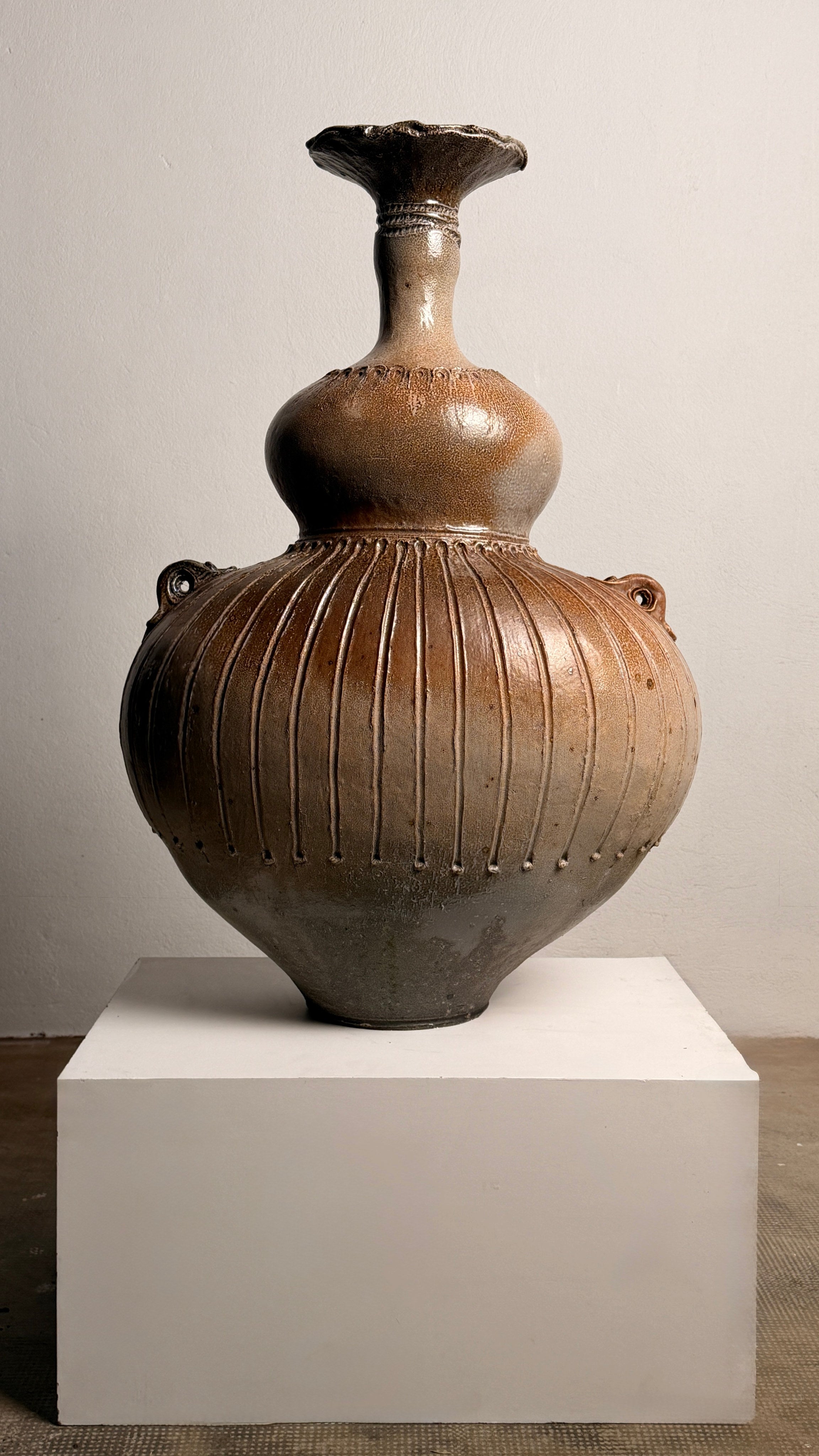 Monumental handled vase by Gustave Tiffoche — front view on white pedestal