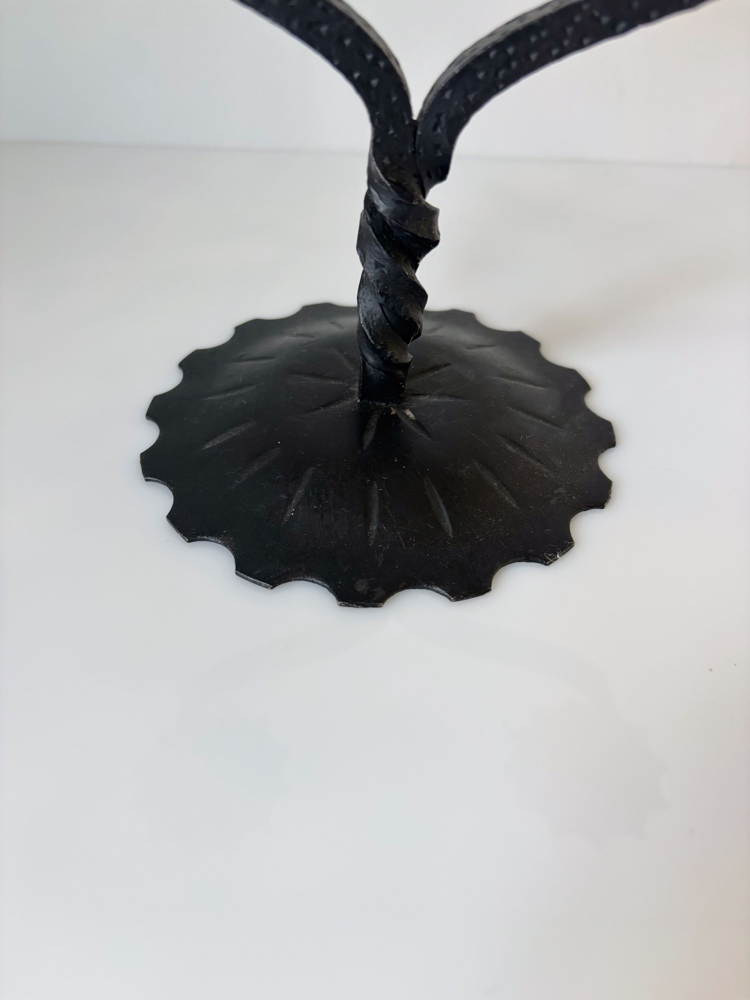 Black metal candleholder with scalloped leaf base detail