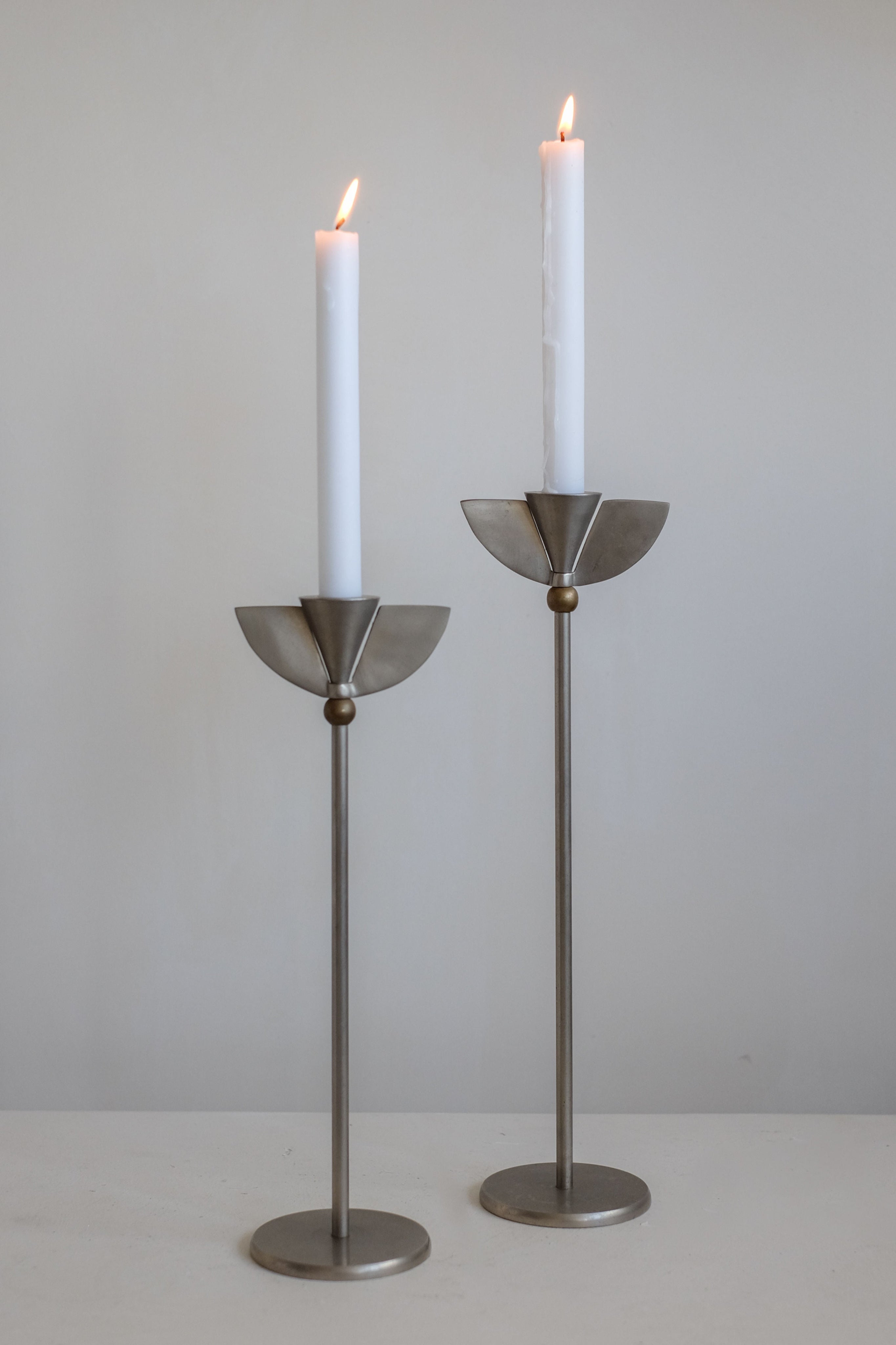 Set of 2 Memphis Candleholders — close-up of metal base with candles