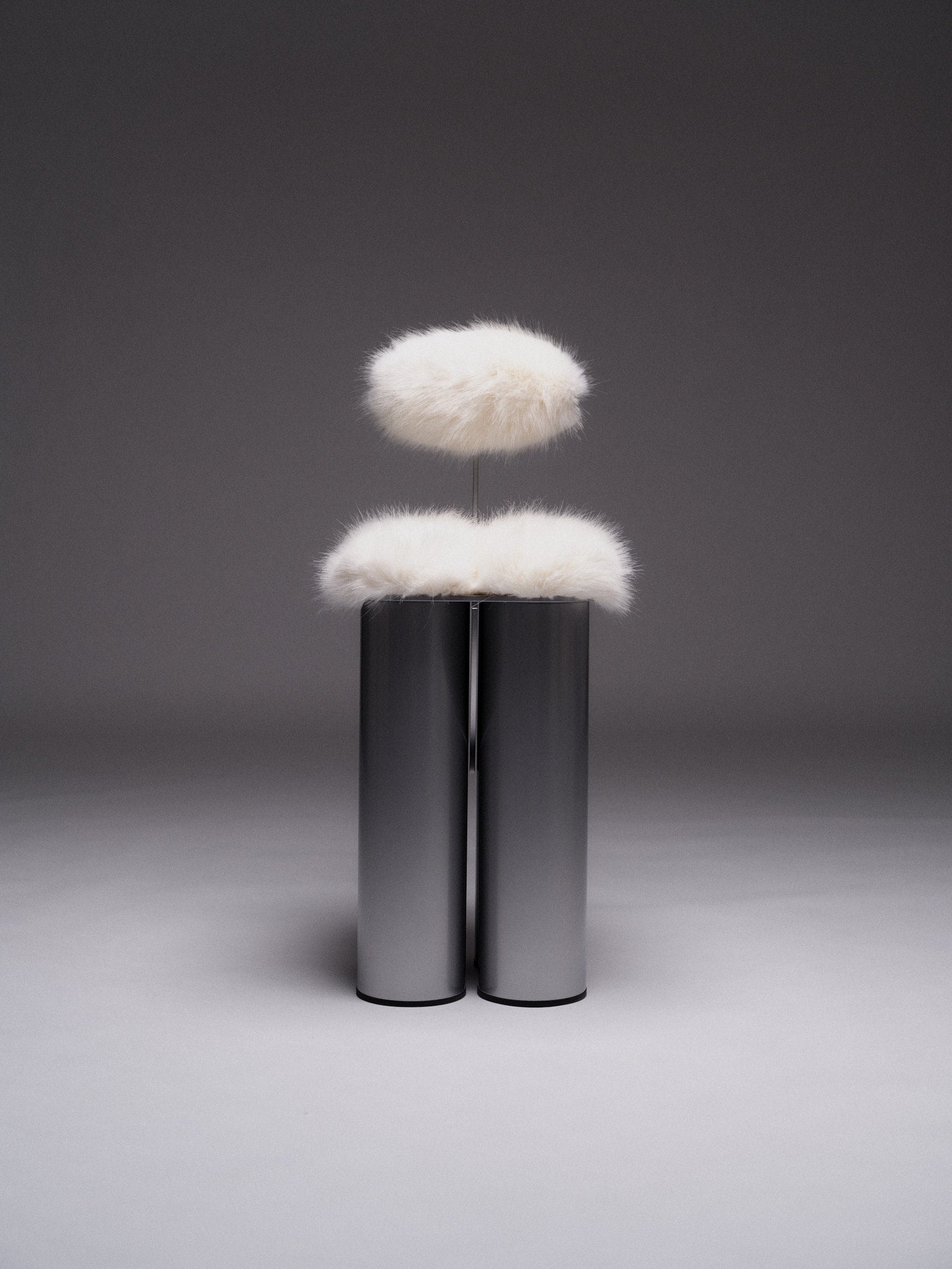 Giulio Stool — back view with white fur and metallic base