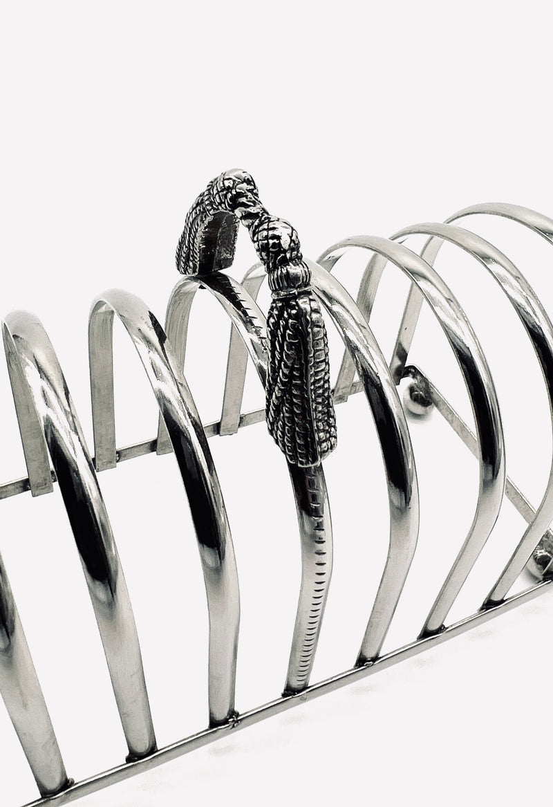 Silver-plated toast rack with ornate tassel handle detail view