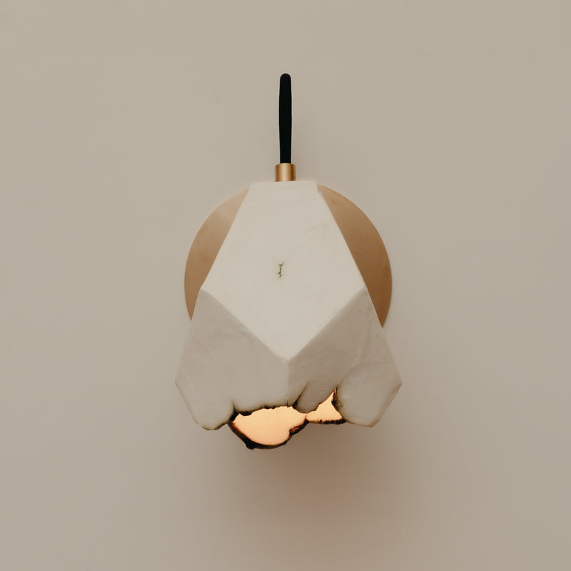 Relic Spotlight Sconce — close-up of white plaster and brass details