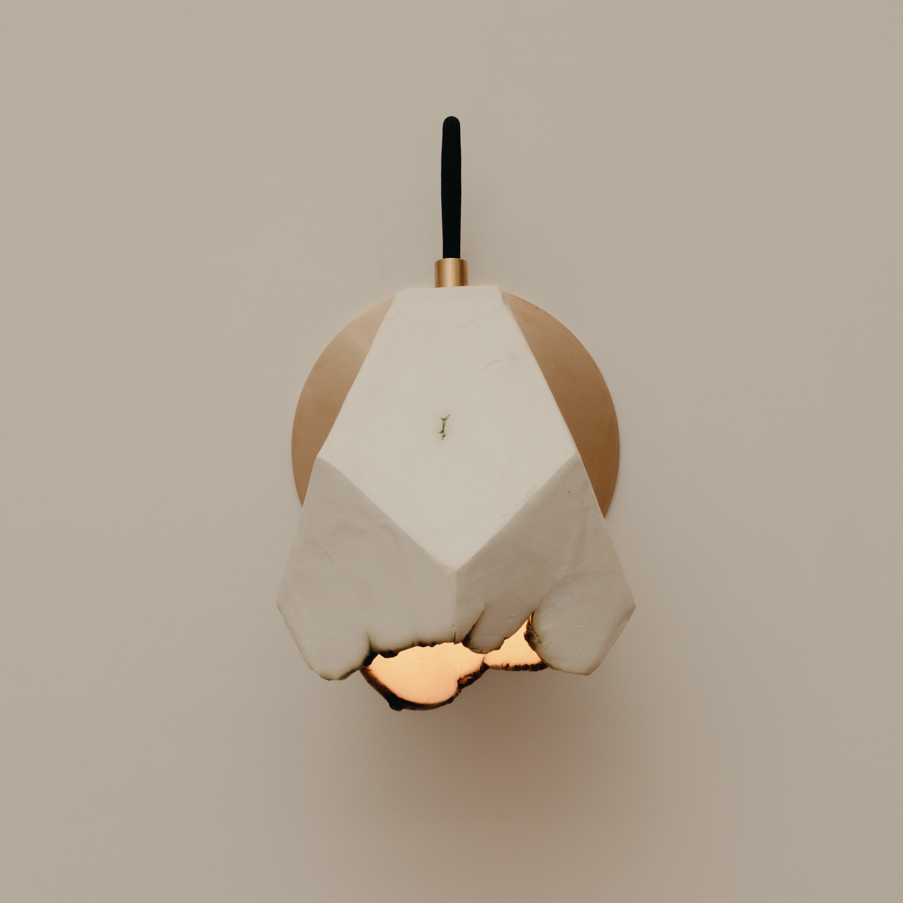 Relic Spotlight Sconce — close-up of white plaster and brass details