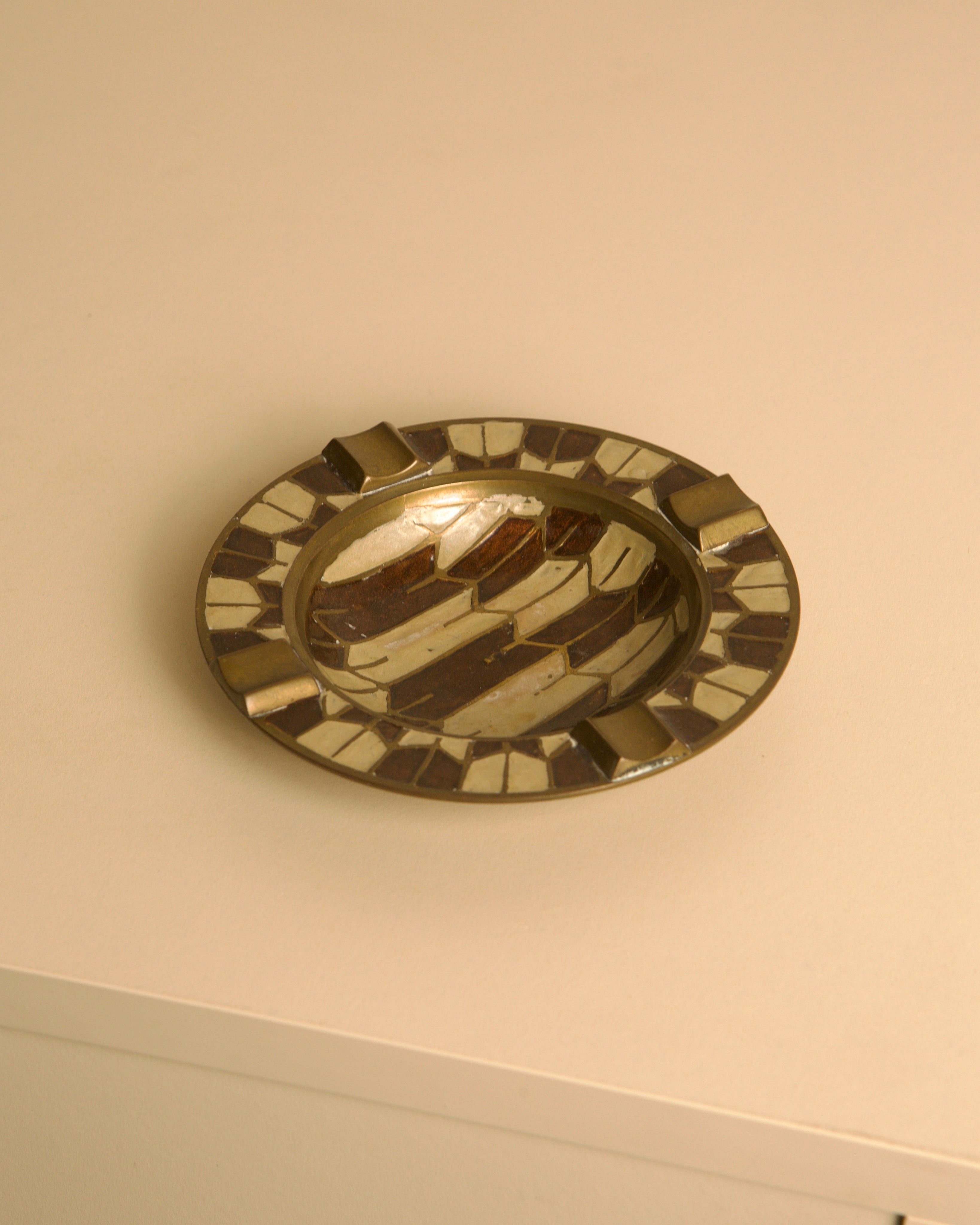 50's Brass Ashtray with Enameled Patterns — close-up of brass with colorful enamel details