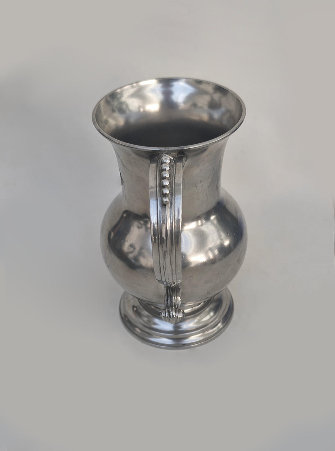 Small Pewter Pitcher — side angle showing polished metal finish