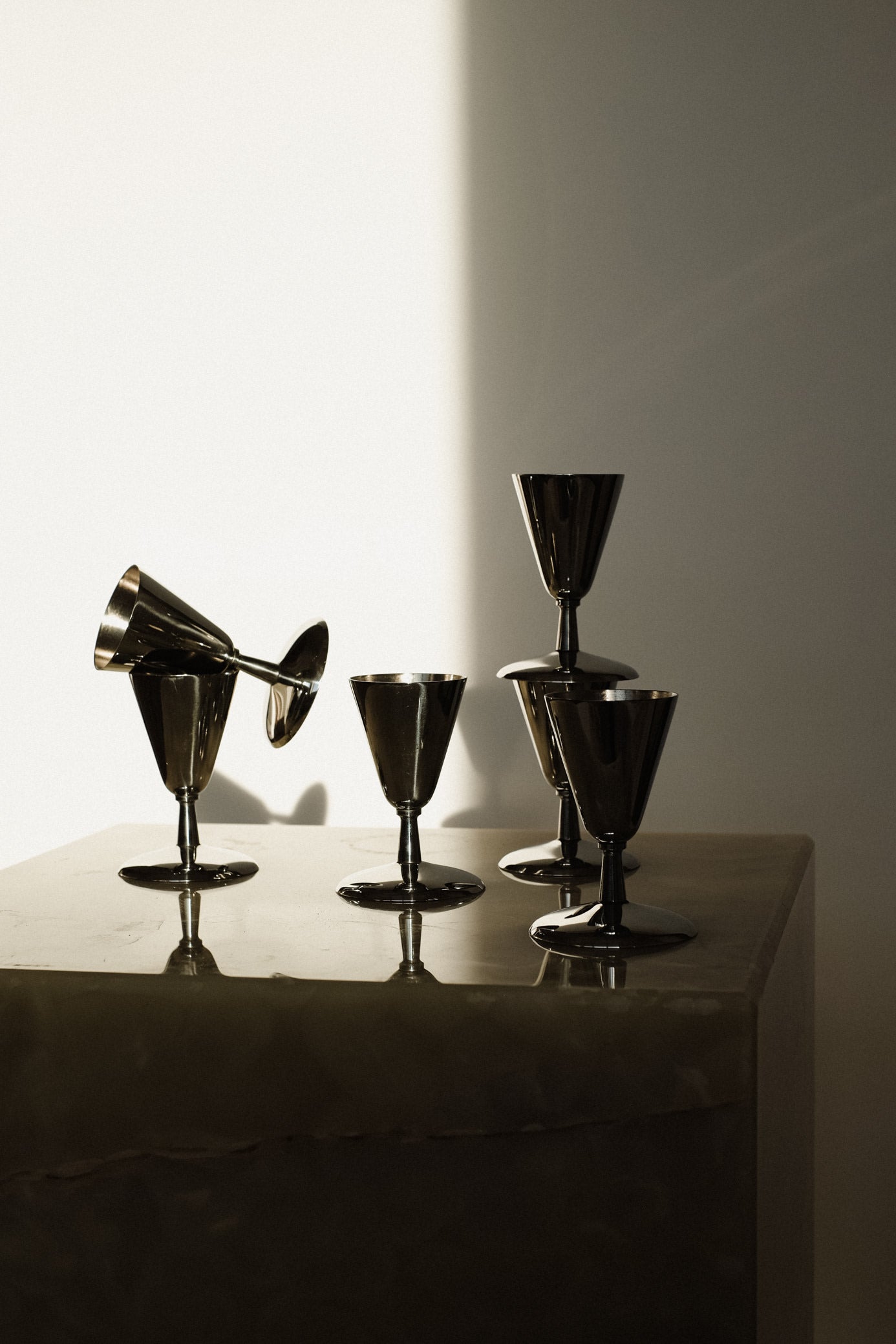 Set of 6 Coupes — top view of metallic glasses on marble surface