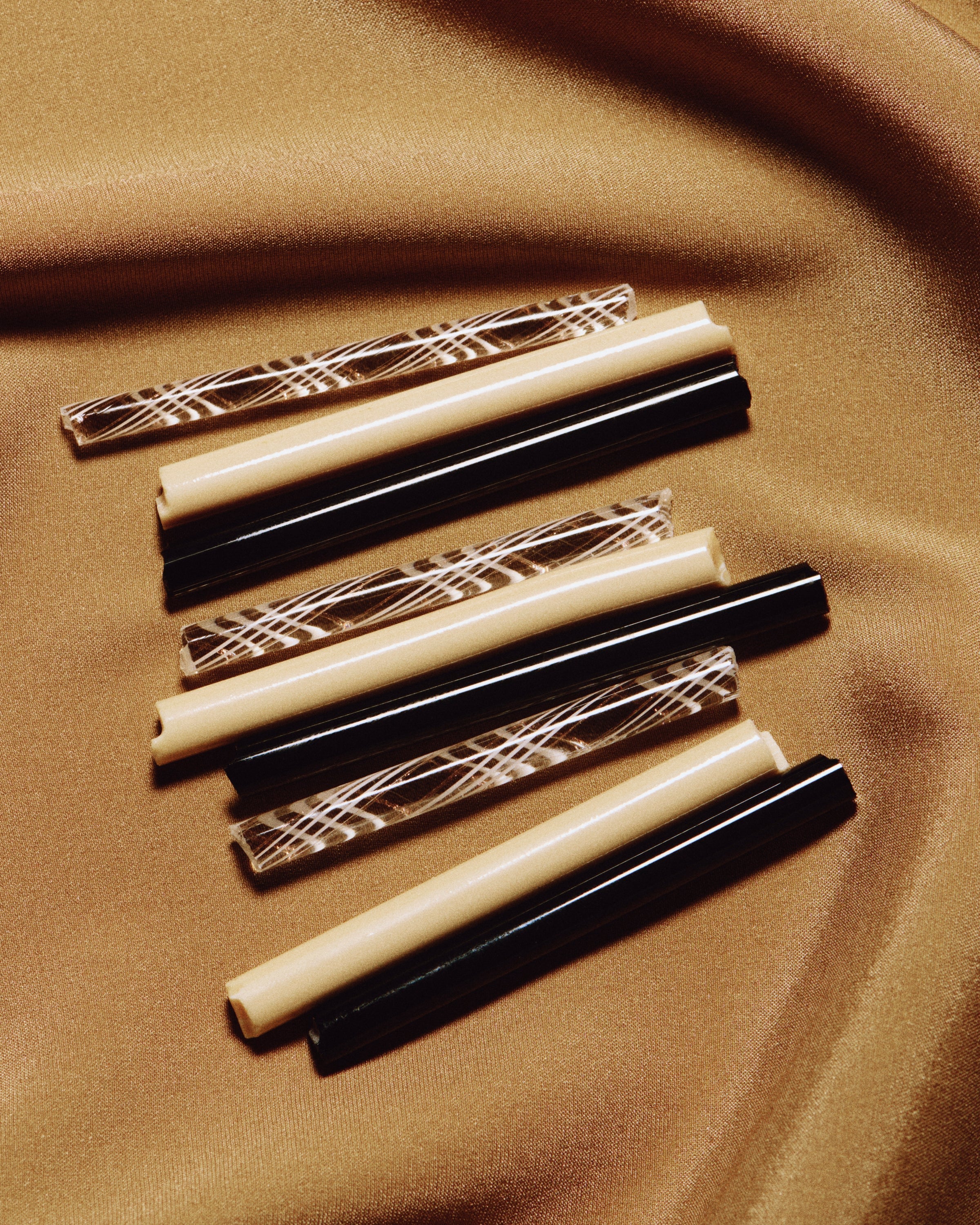 Clara Glasses - Set of four — close-up of patterned glass straws on fabric