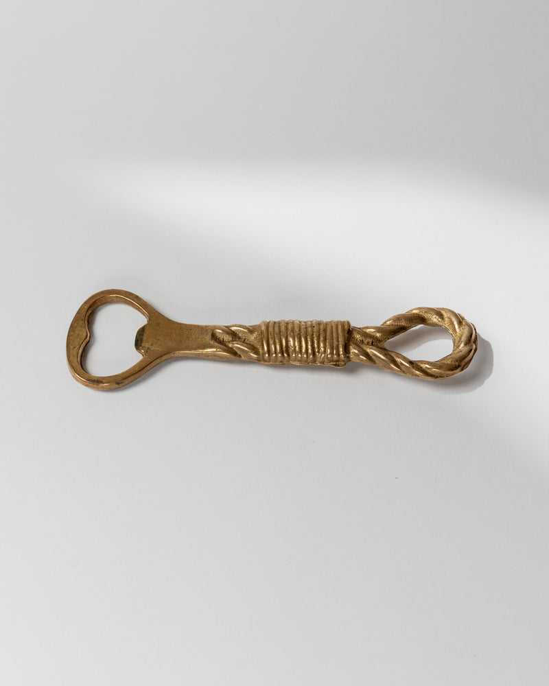 Vintage brass bottle opener with twisted rope design detail