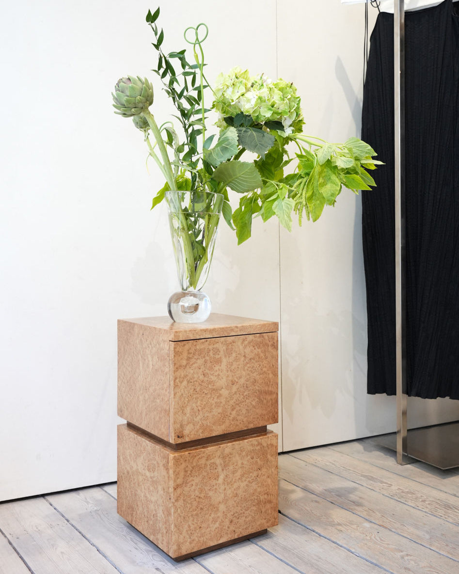 Bohult Due' Bedside Table — back view with natural wood finish and plants