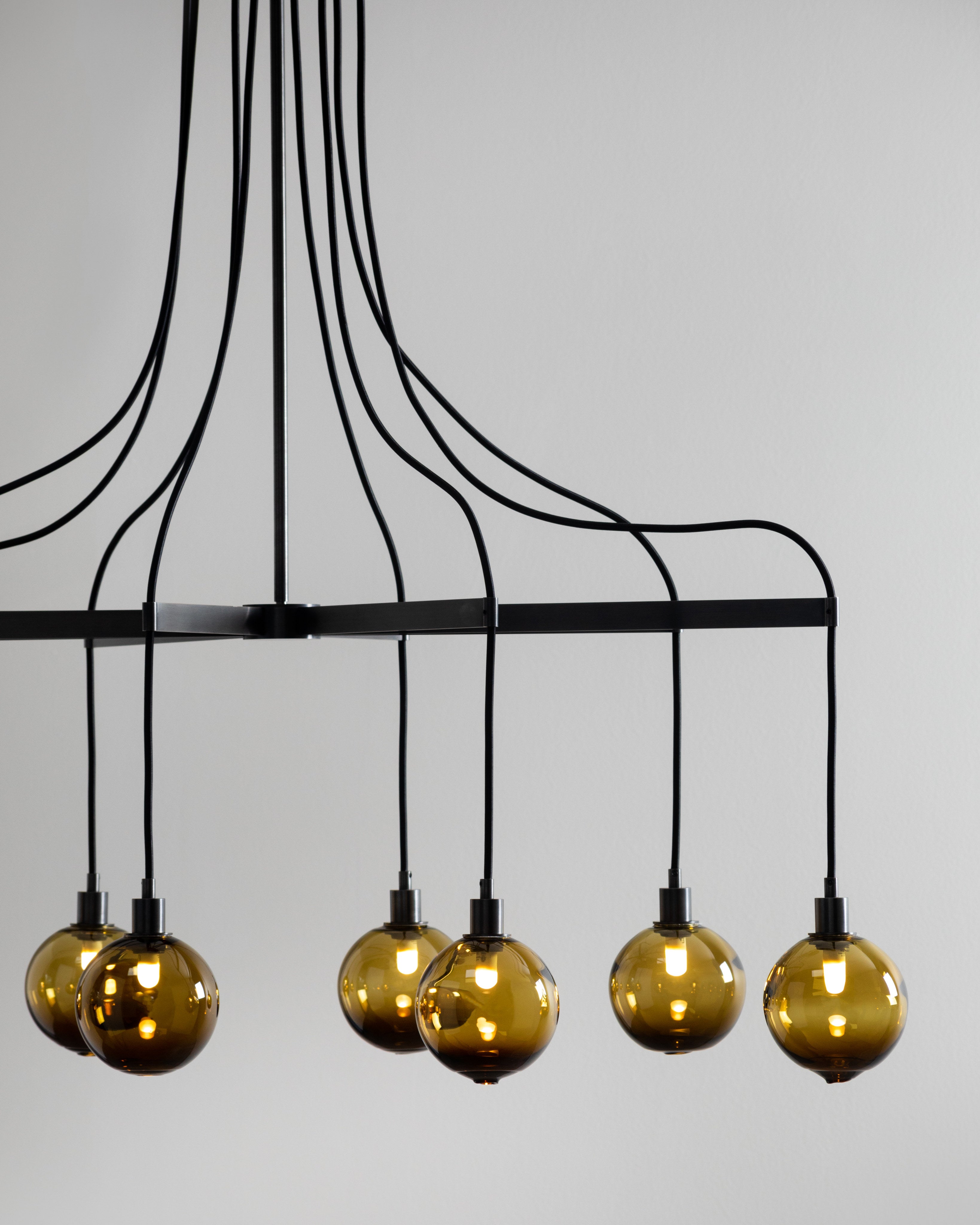 SkLO Drape Arm 8 Chandelier - Olivin glass, Dark Oxidized finish — close-up