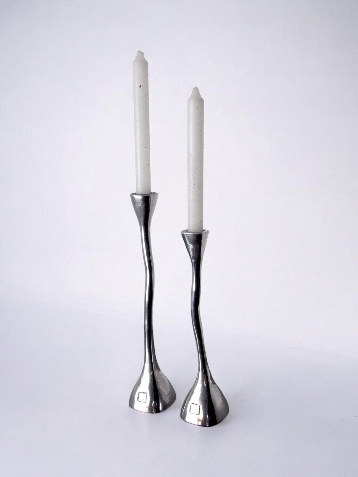 Pair of Candleholders, art3, Spain, 1970s — side angle showing polished metal finish