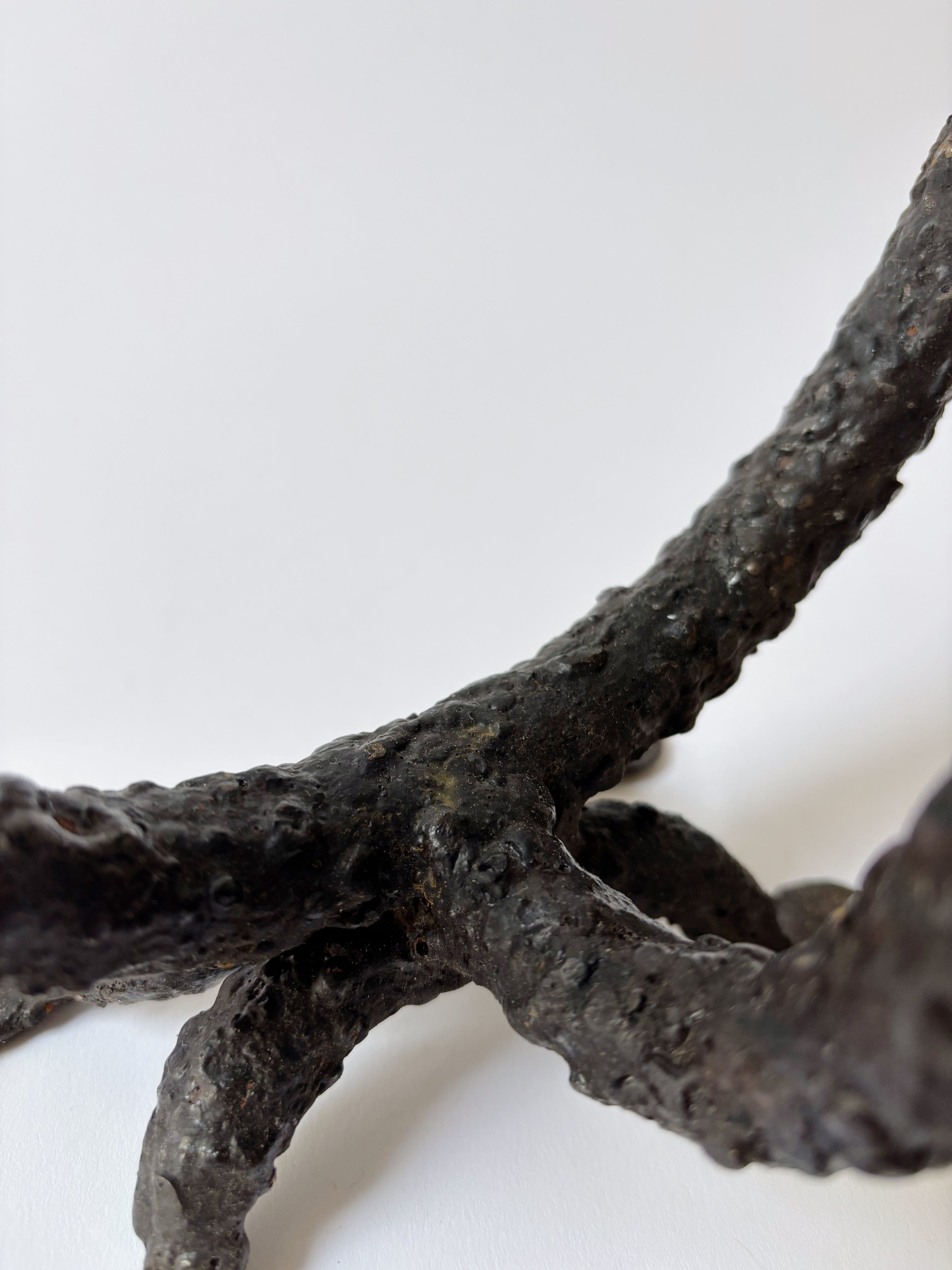 Metal Textured Artisan Candlestick, Poland — close-up of textured black metal base