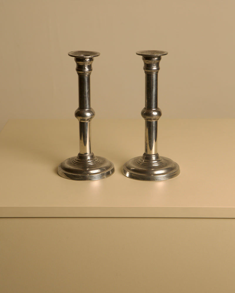 Pair of Italian Metal and Aluminum Candleholdersc80s — close-up of polished metal finish