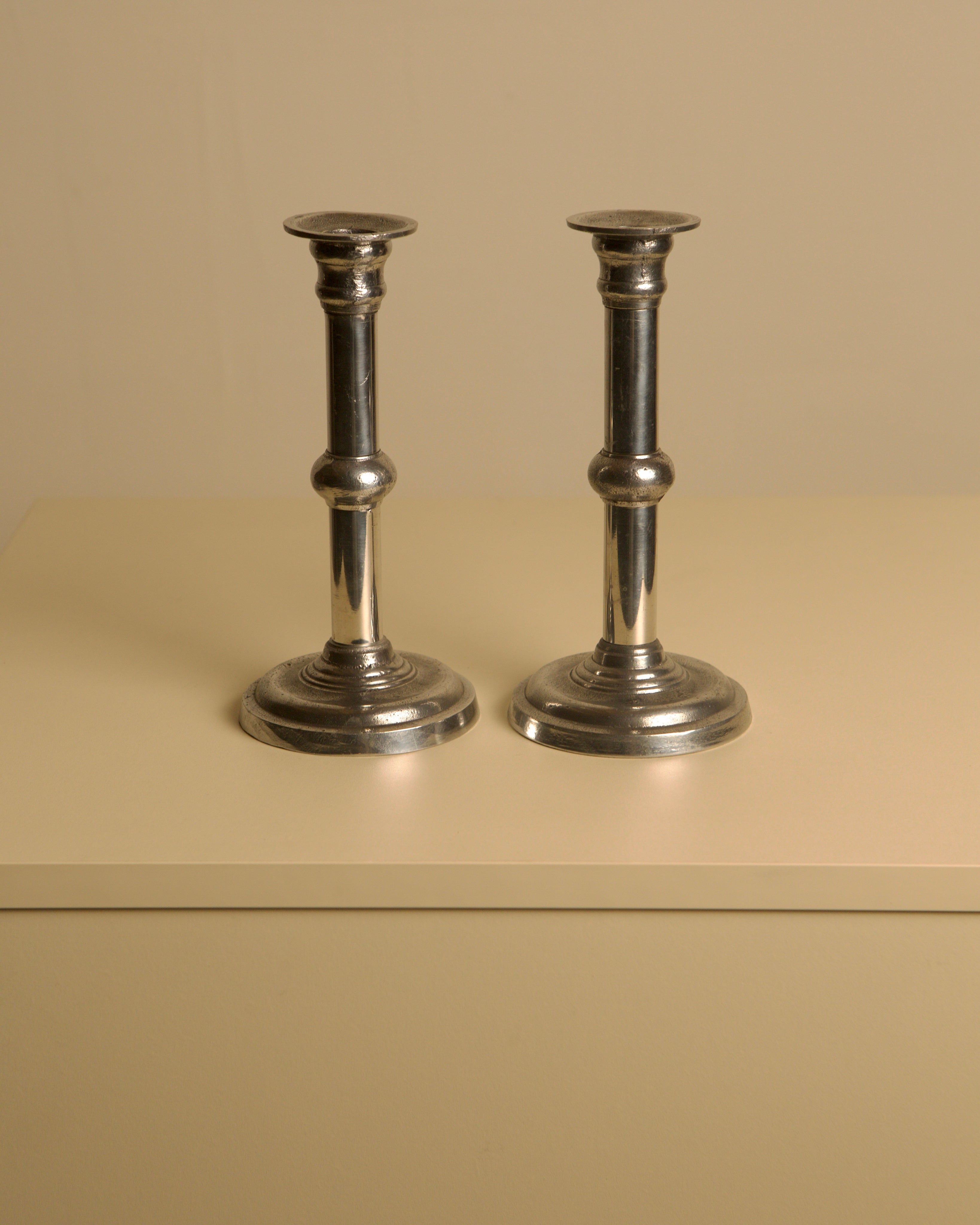 Pair of Italian Metal and Aluminum Candleholdersc80s — close-up of polished metal finish