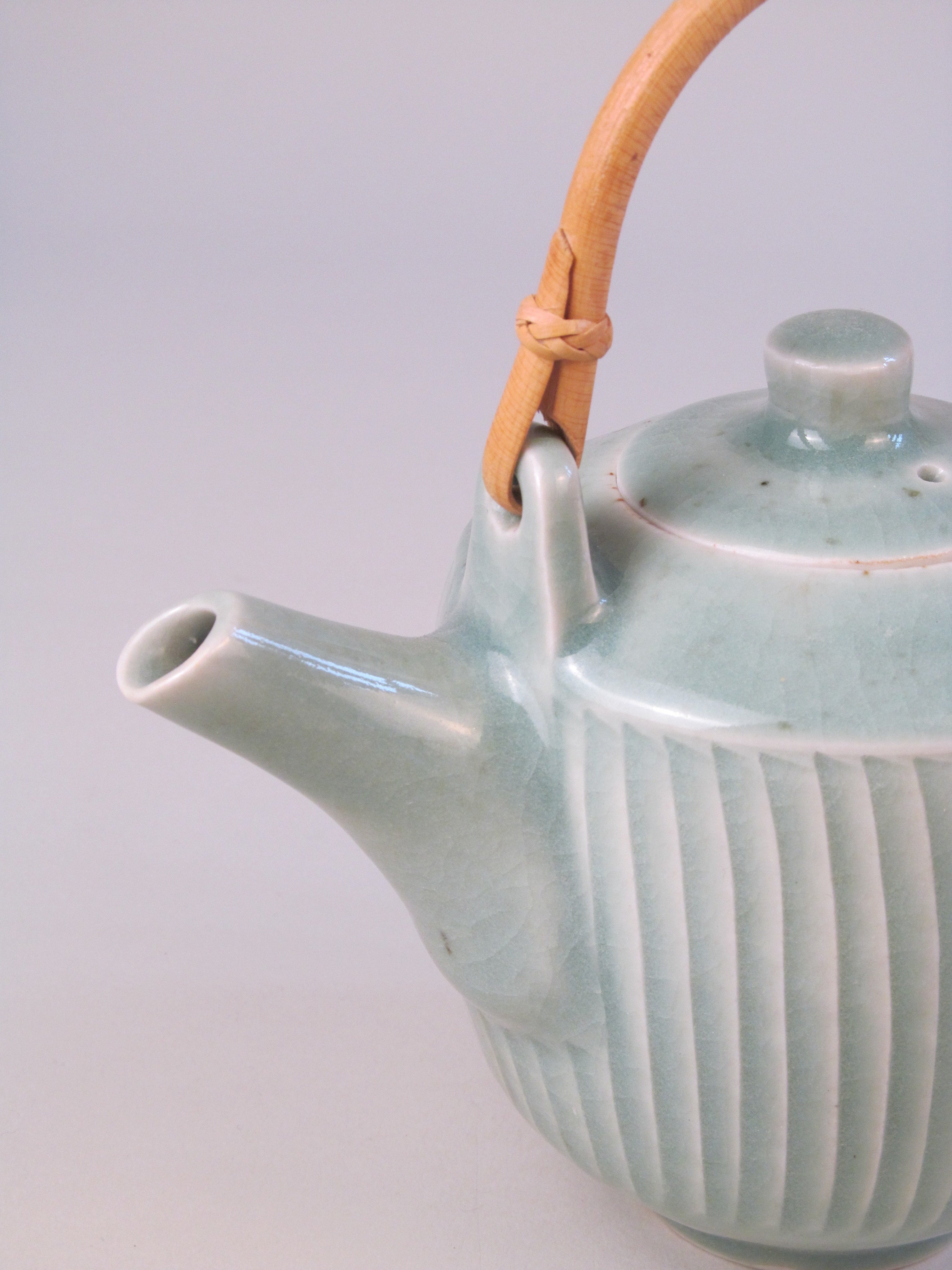 David Leach (1911-2005) Celadon Ribbed Teapot — close-up of celadon ceramic with bamboo handle