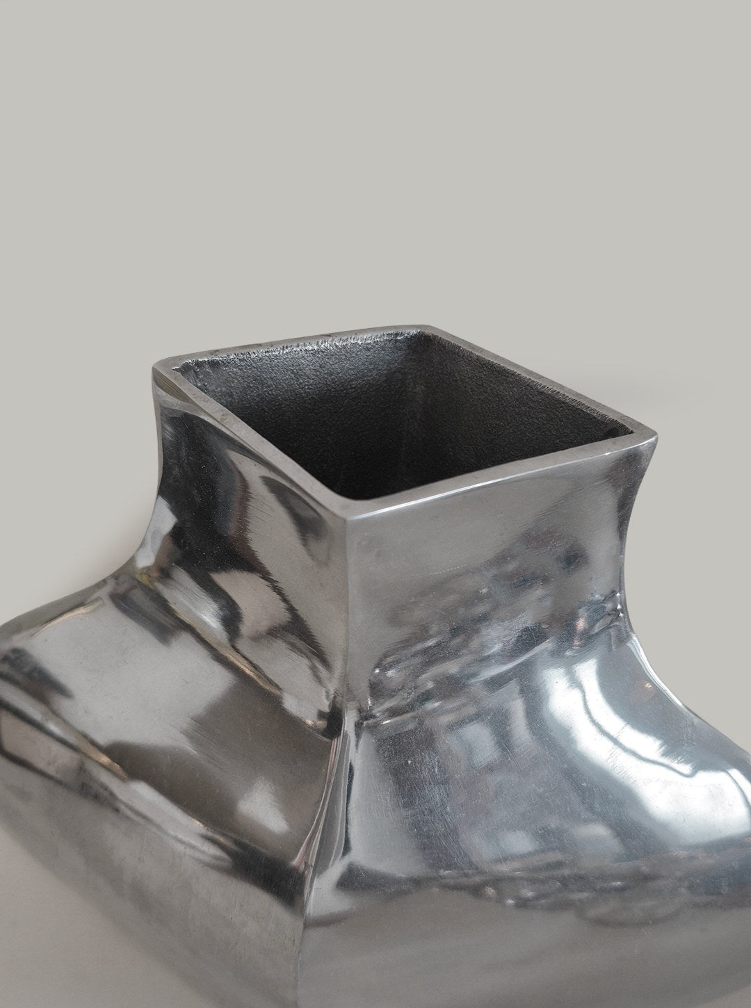 Sculptural Chrome Vase — close-up showing polished chrome surface