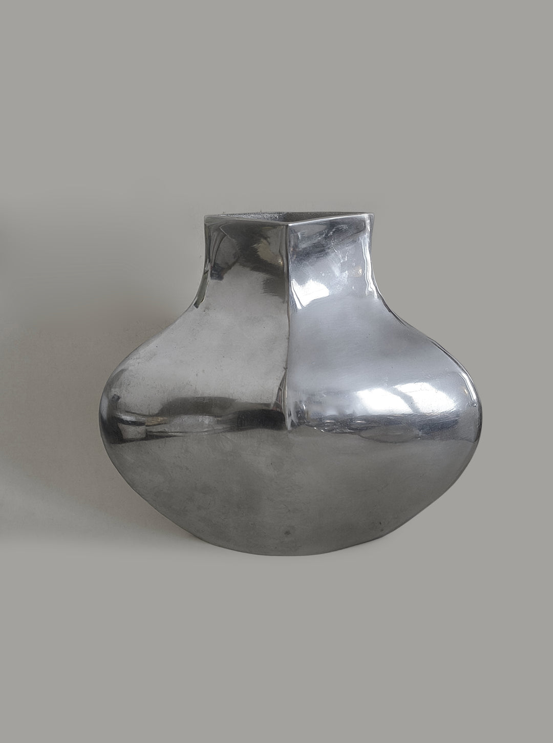 Sculptural Chrome Vase — front view against neutral background