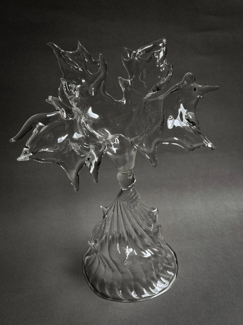 Clear glass sculpture with flowing organic petals on ribbed base