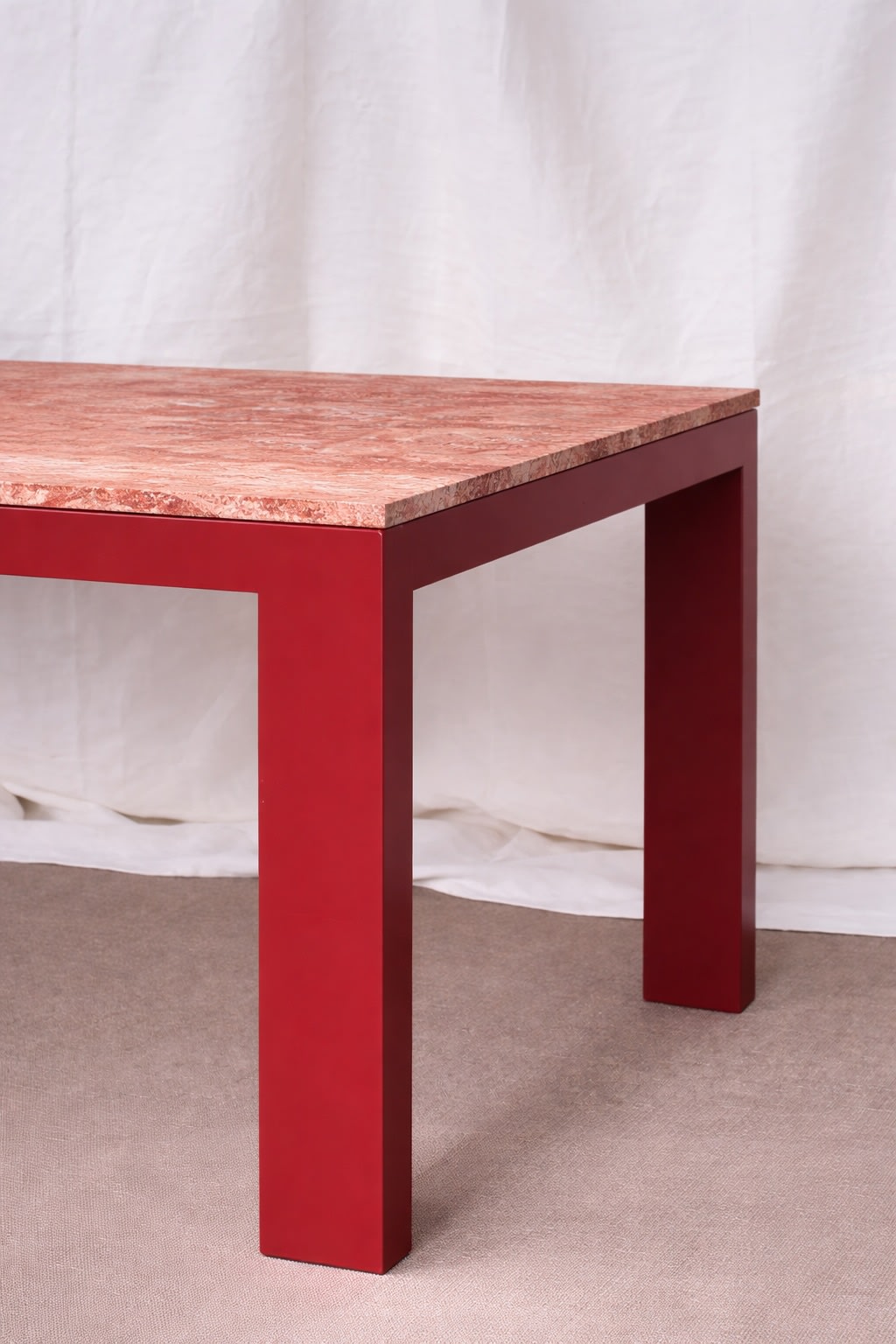 Firme Dining Table — close-up of red base with marble top