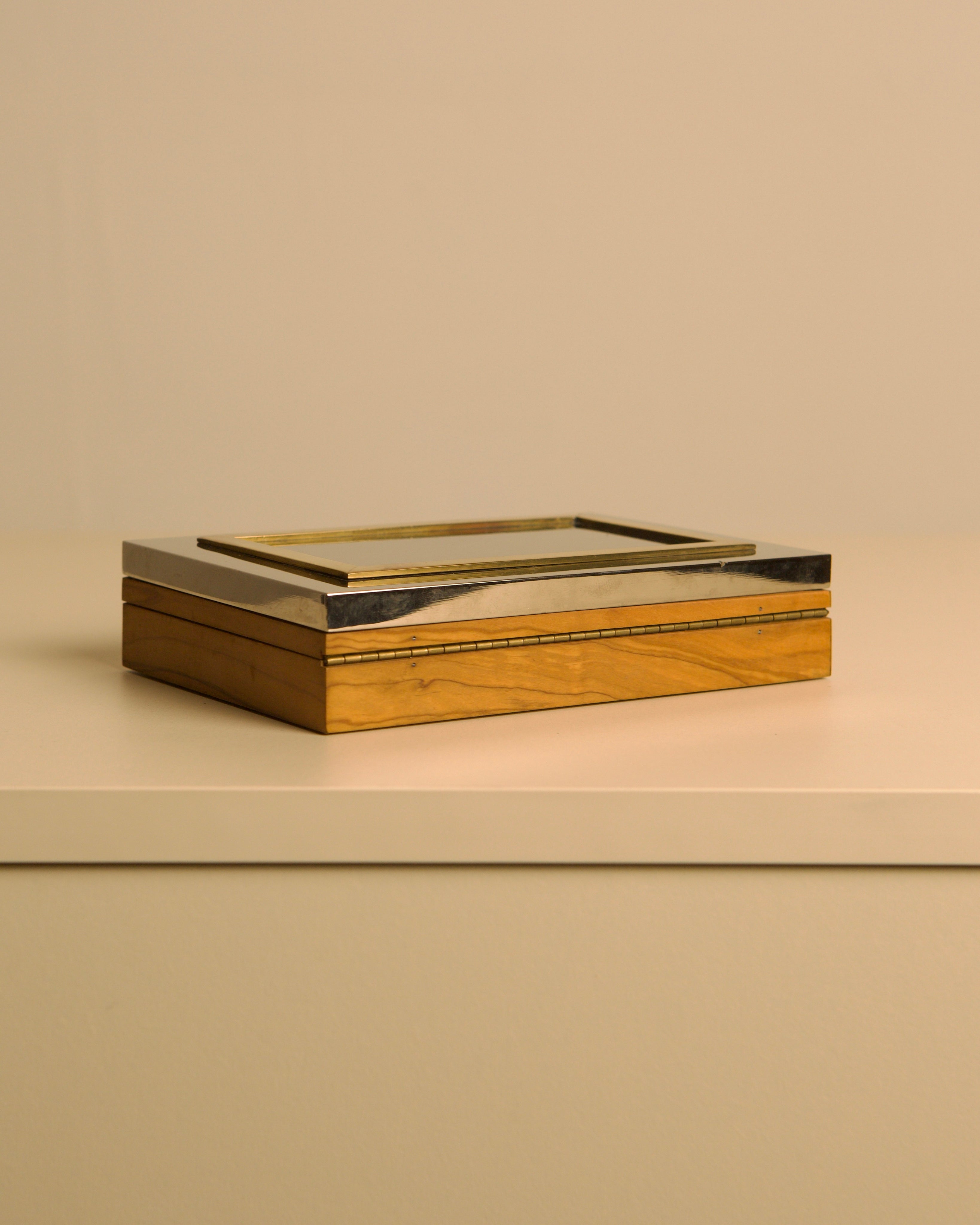 Italian box in metal, brass and solid olive wood, 1970s — angled view on neutral surface