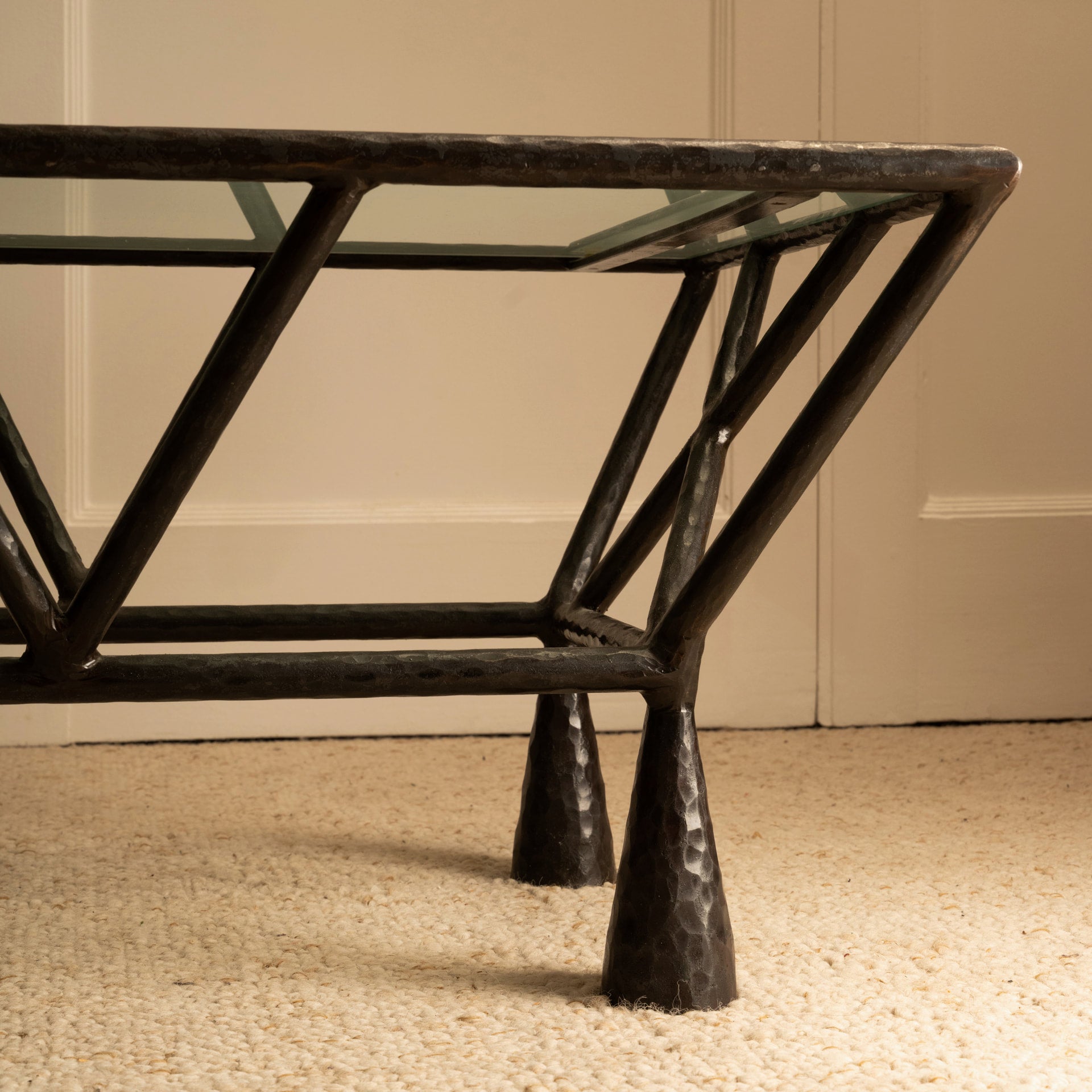 Zebra Coffee Table — side angle showing black metal legs and glass top