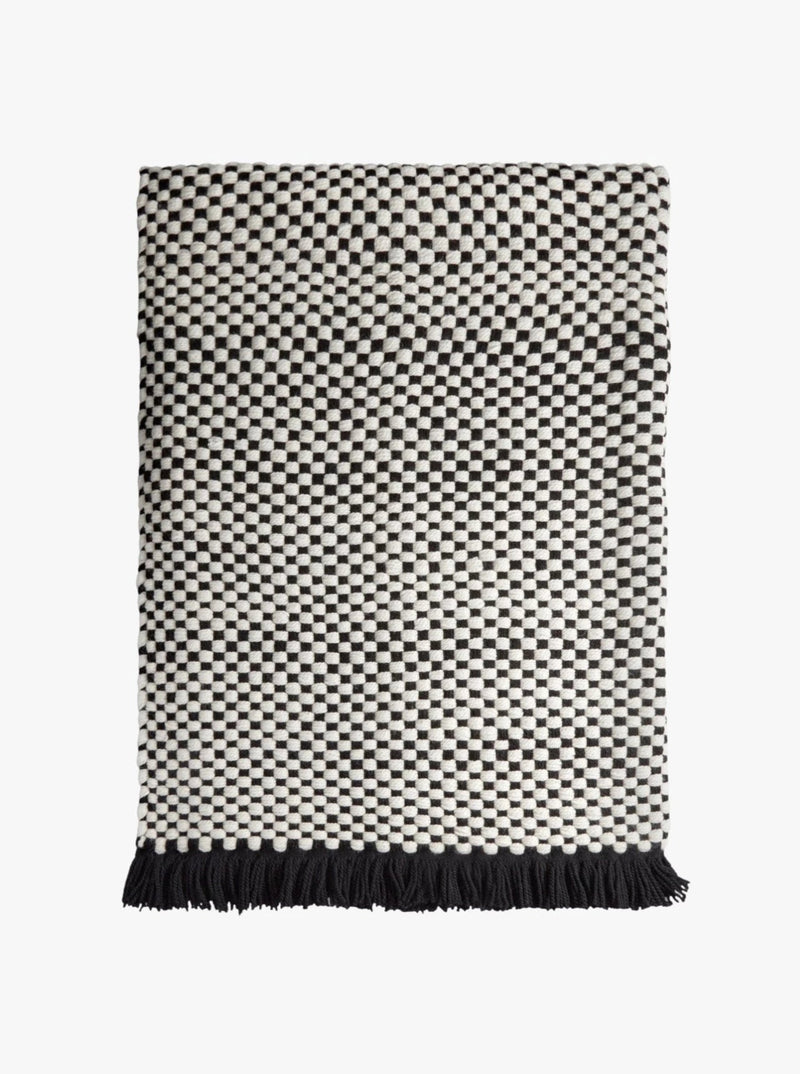 Damier Throw - Black — close-up of woven black and white fabric