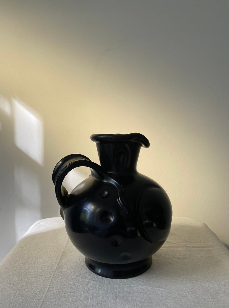 Black art deco ceramic vase with curved handle and spout design