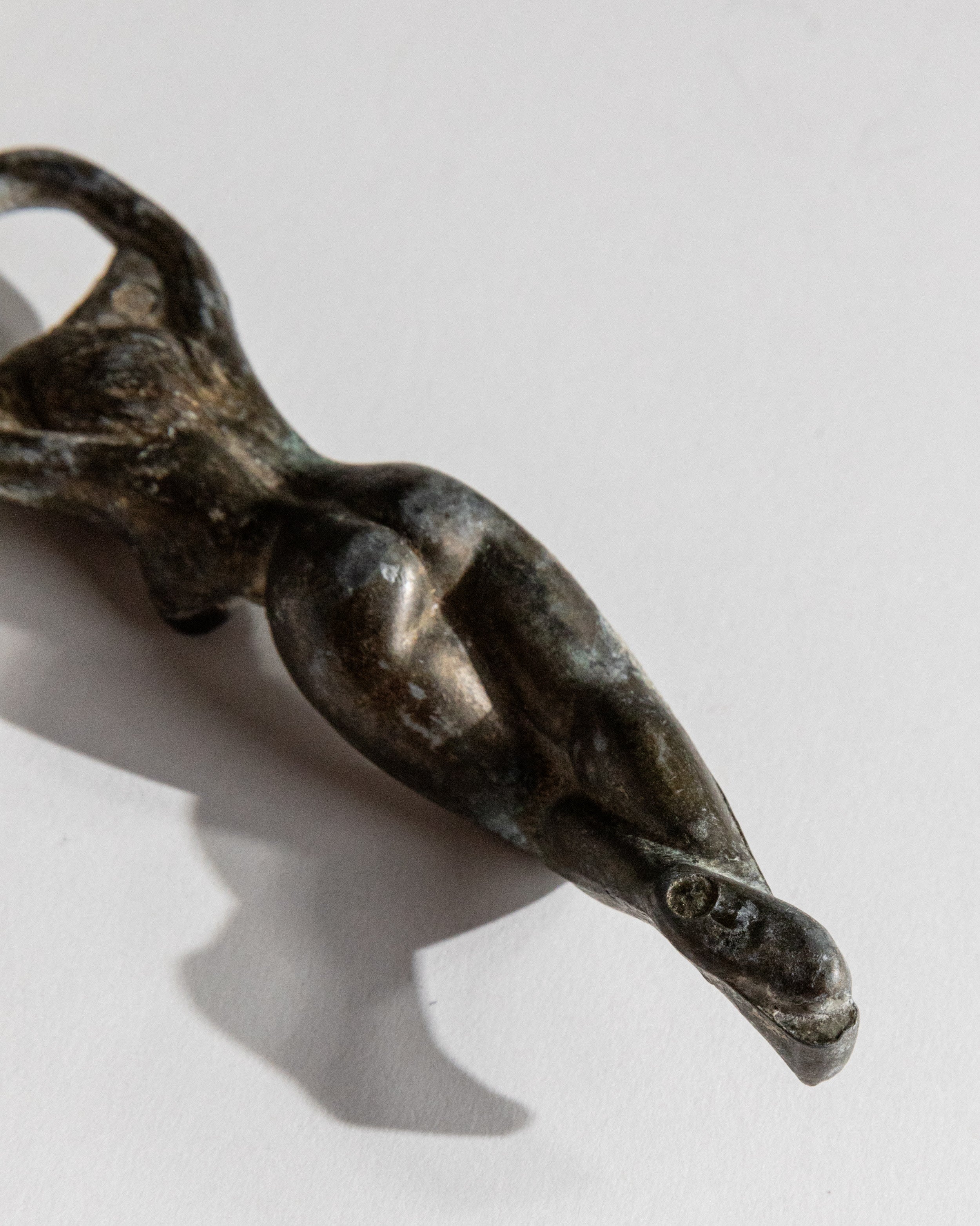 Vintage 1940s Bottle Opener Brass, Nude Woman Shape — close-up of textured brass surface