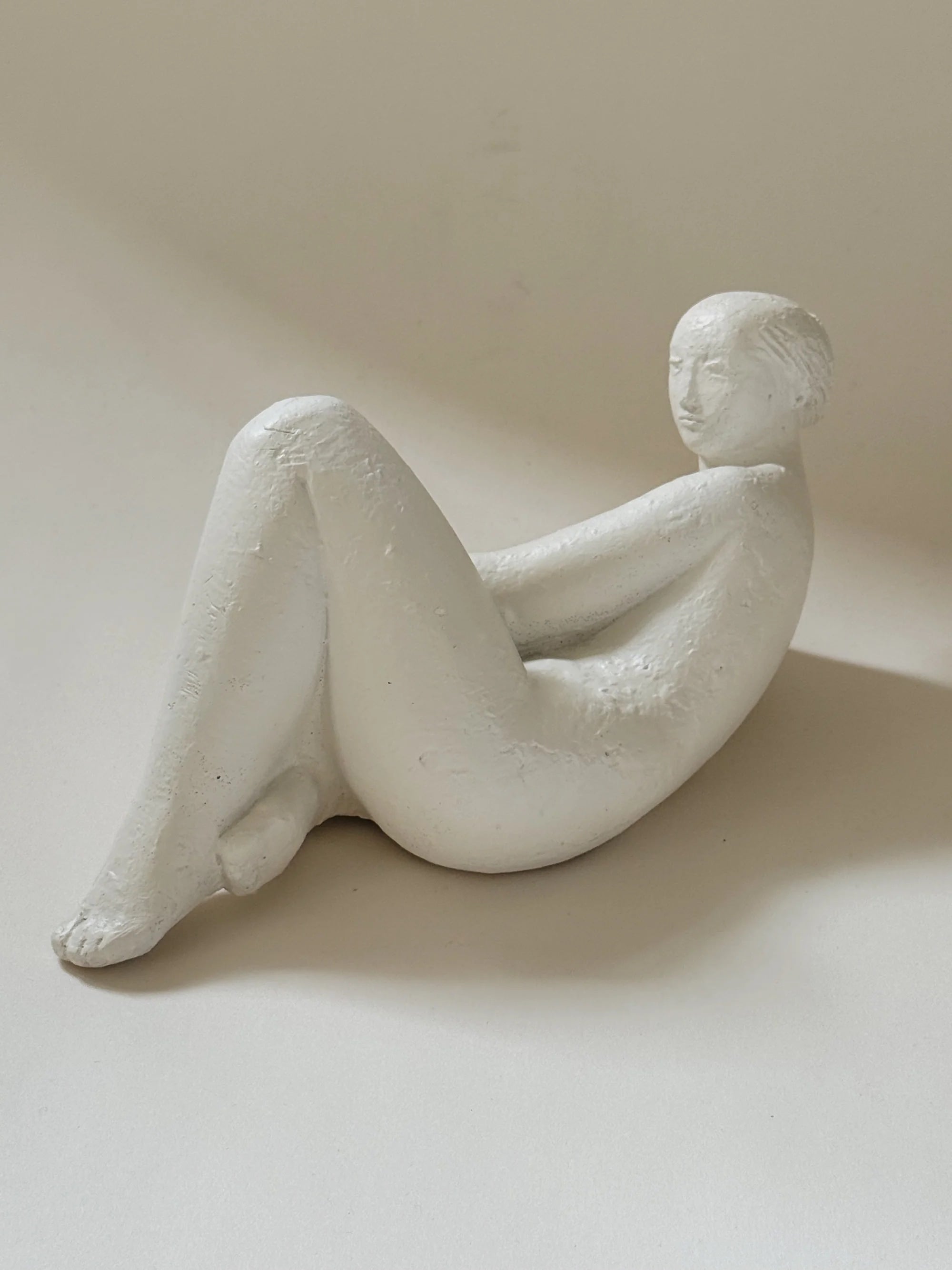 Reclining Female Figure Sculpture, Jan Keustermans — side view on neutral backdrop
