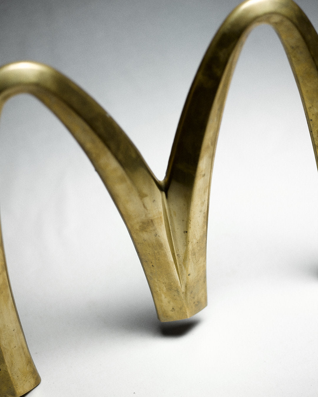 Vintage Italian McDonalds Sign in Brass — side angle highlighting curved brass design