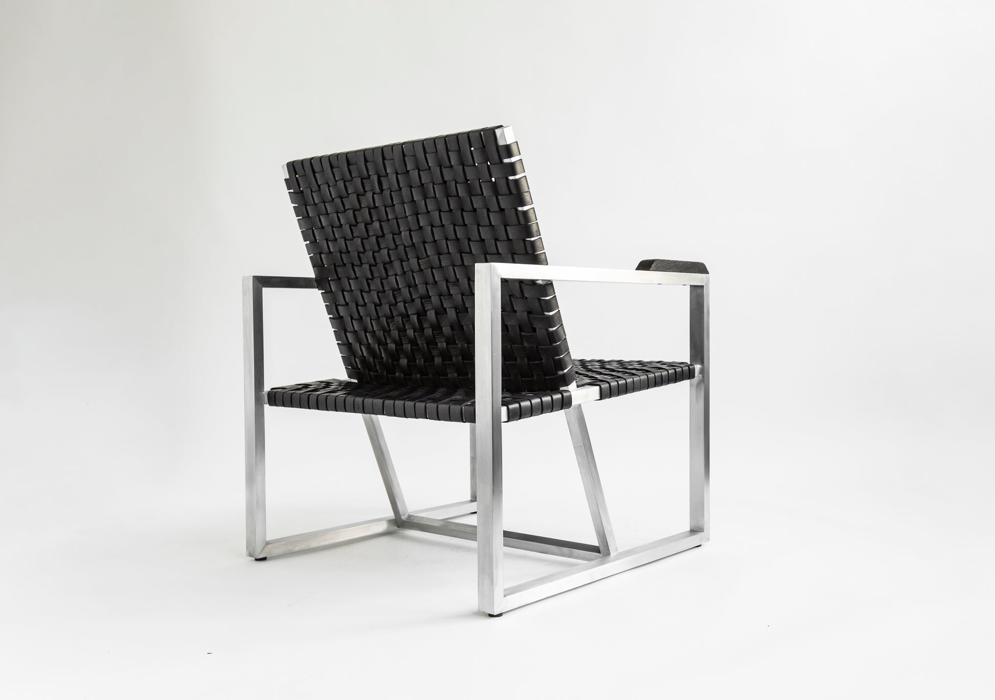 RIA II Lounge Chair — side angle showing woven black seat and silver frame