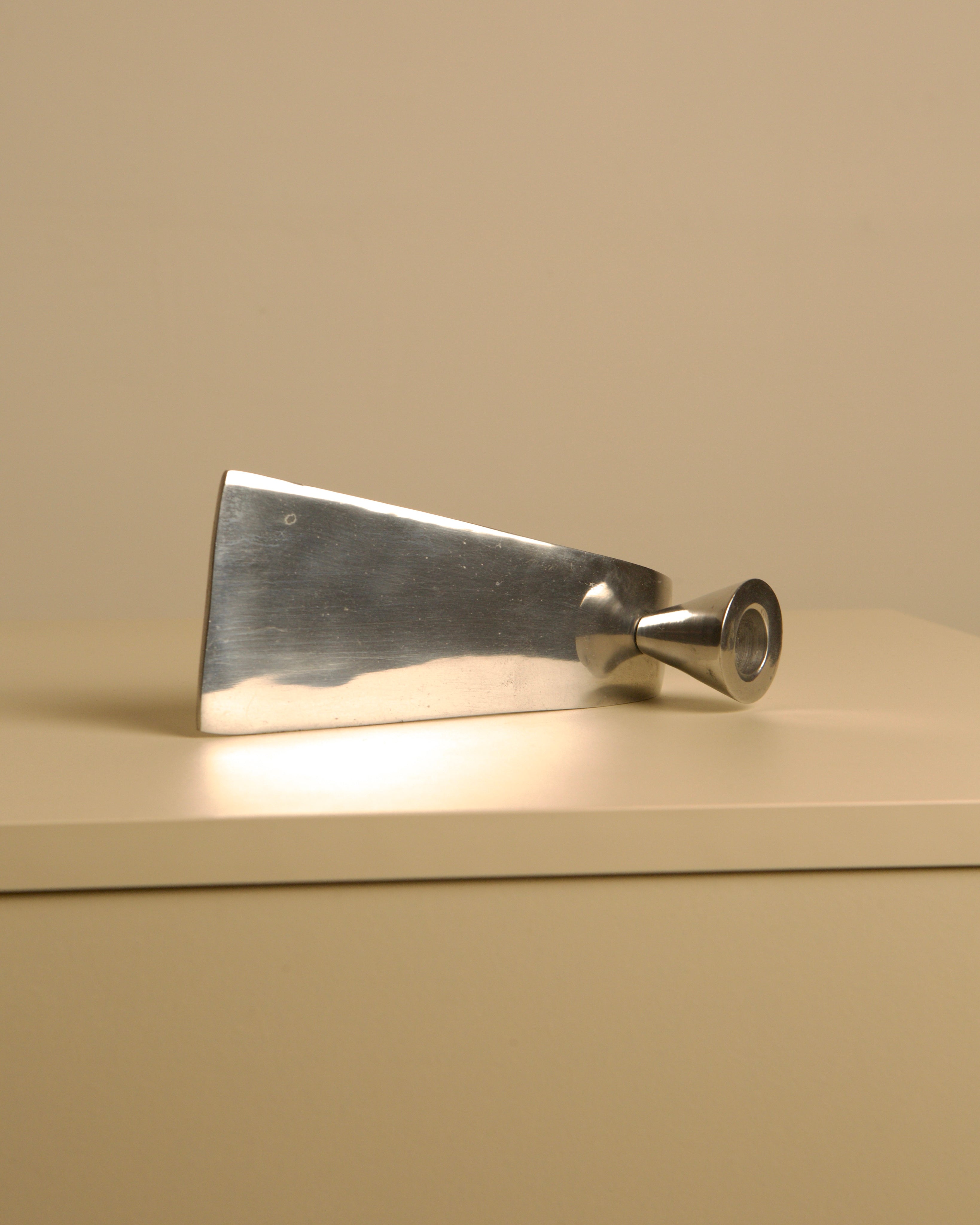 Italian "Wave" Metal Candleholders, 70s — side angle on neutral background