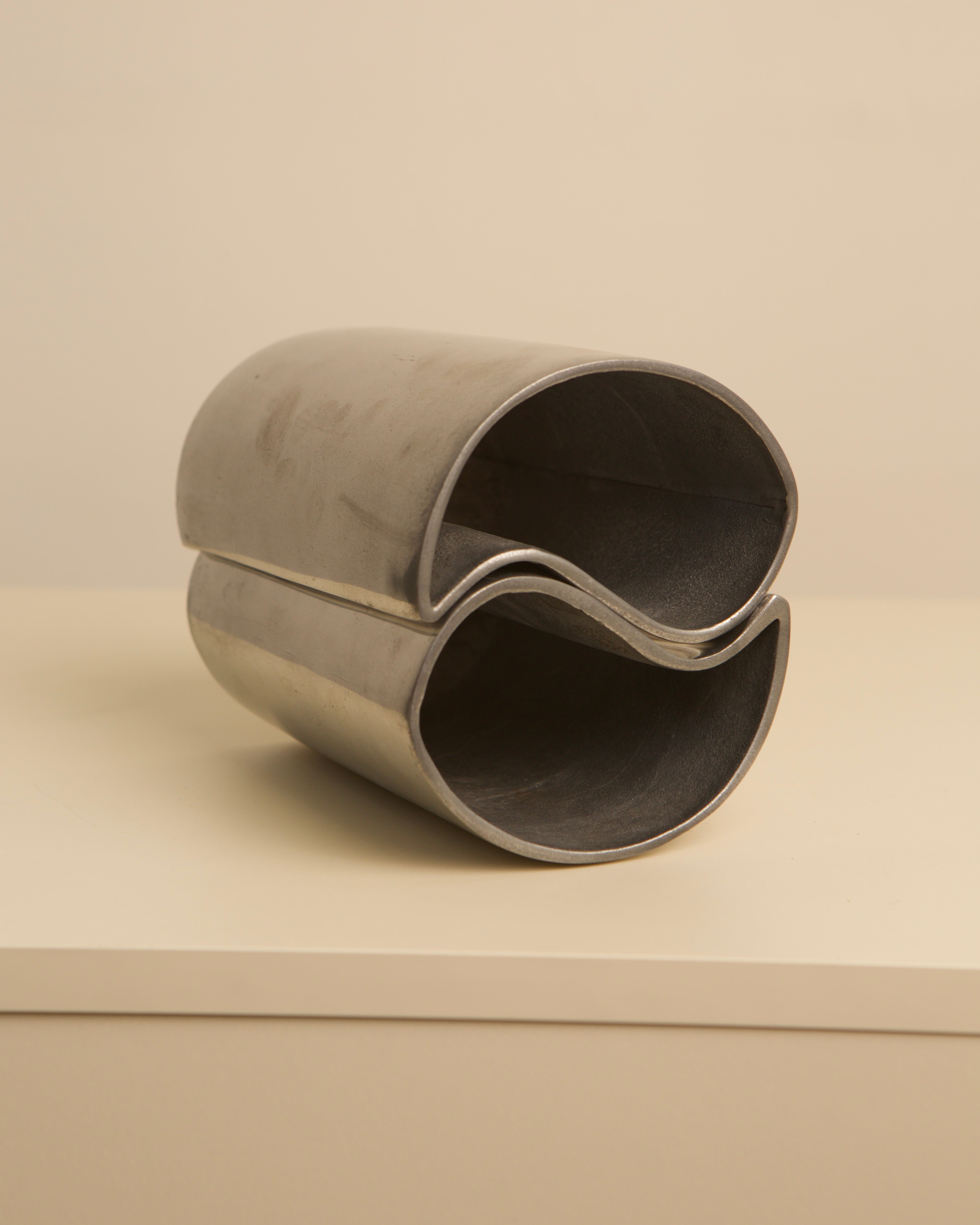 Two interlocking aluminum vases forming yin yang design, 1980s vintage