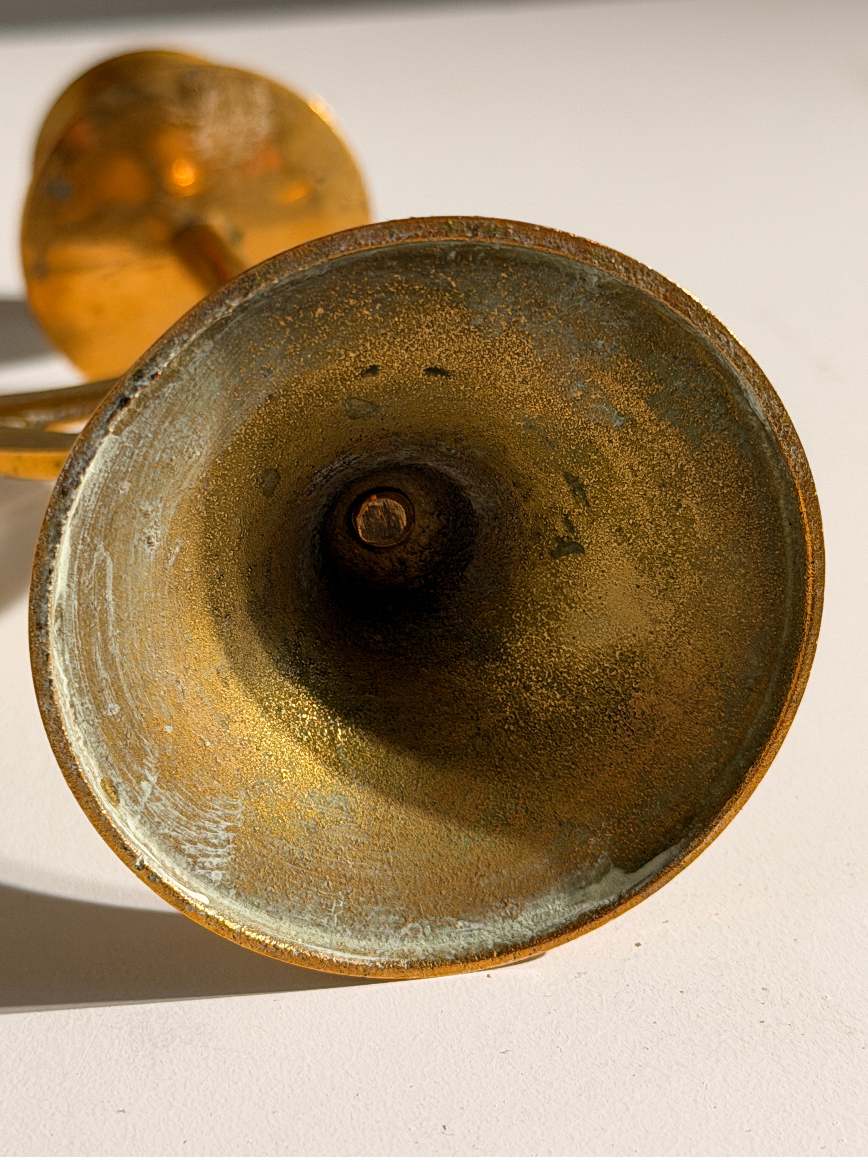 Pair of brass candlesticks with a crescent-moon motif, France, circa 1970 — lifestyle setting