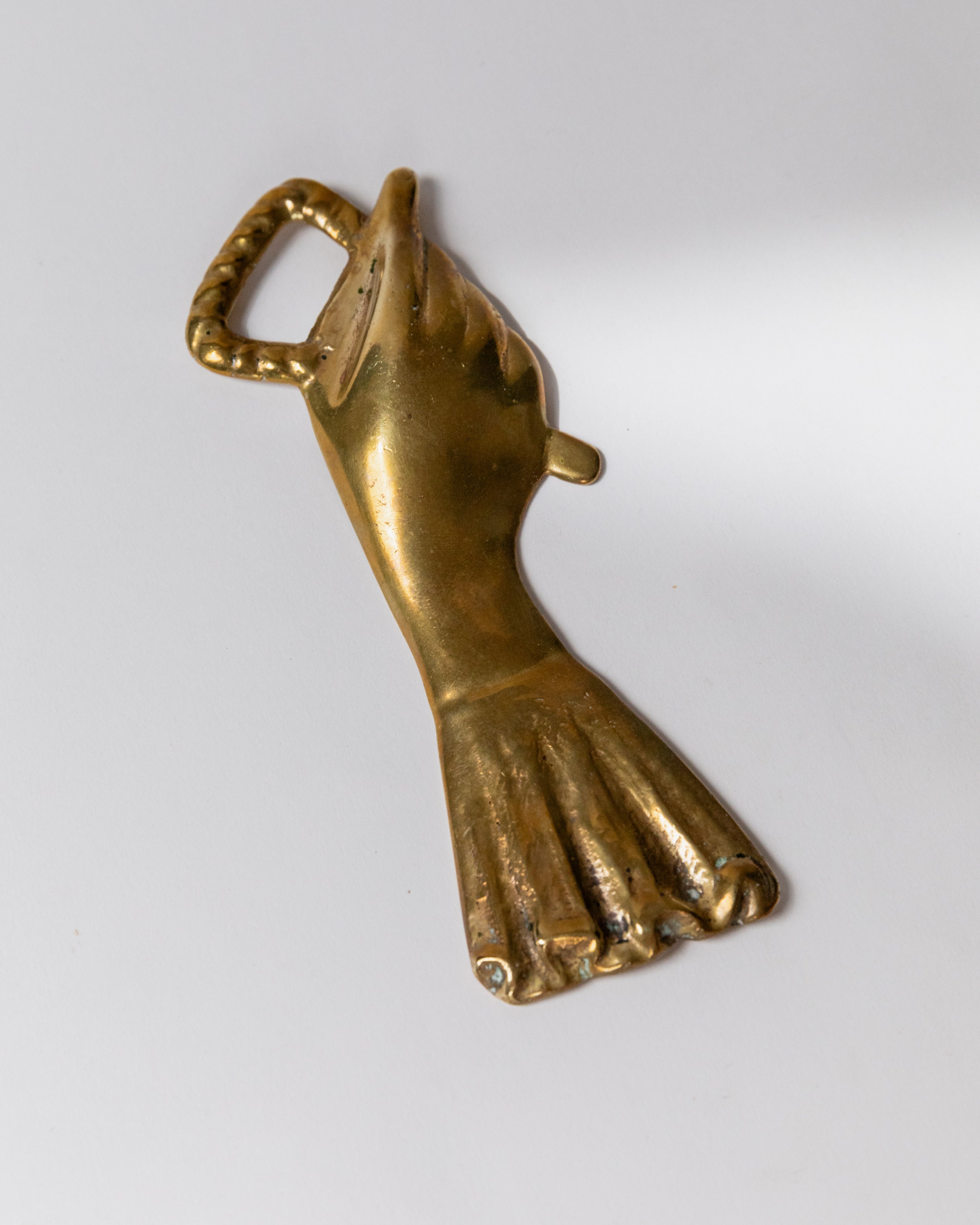 Vintage brass hand-shaped bottle opener detail view, Italy 1950s