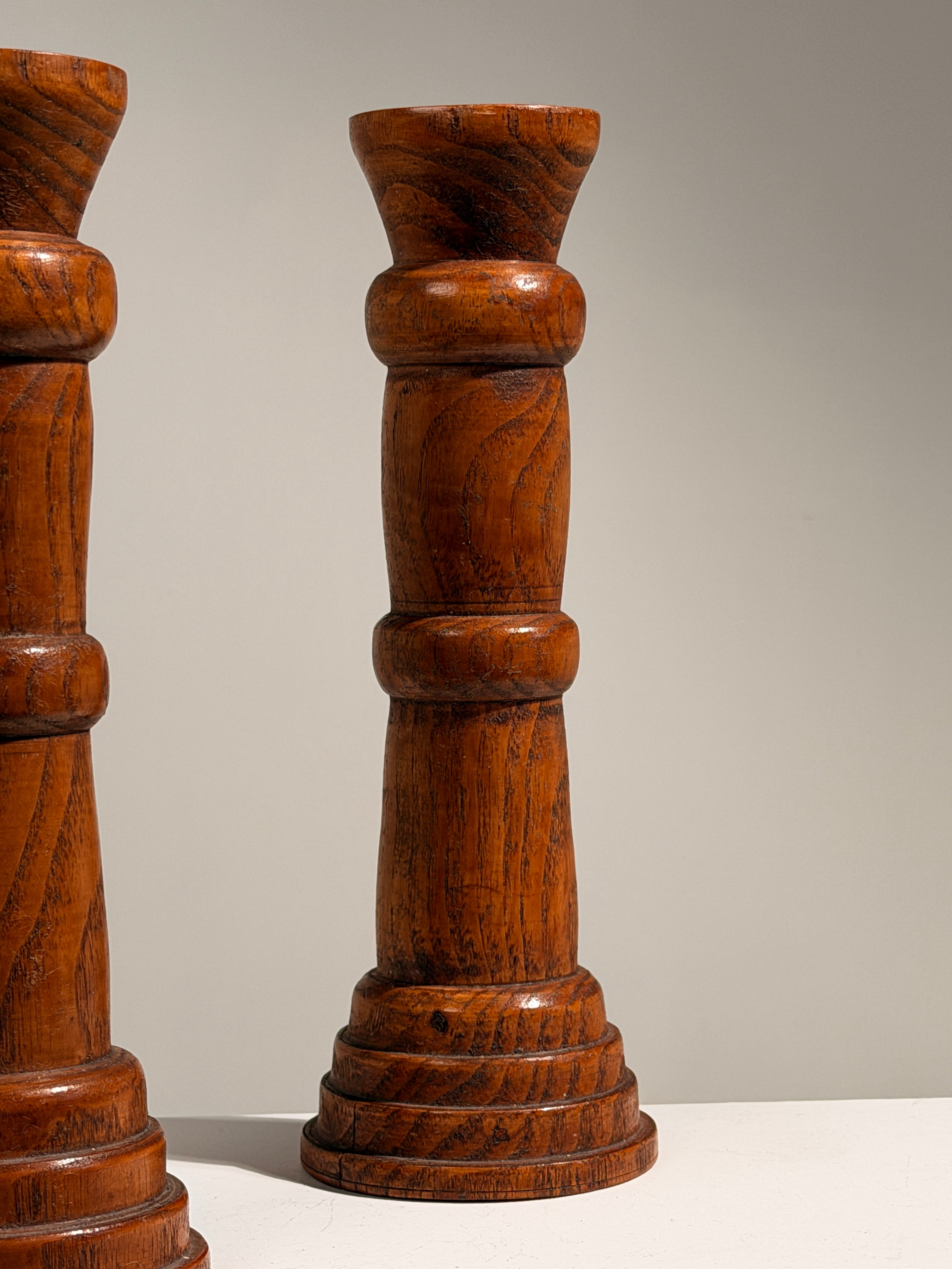 Pair of Brutalist solid wood candlesticks, France, circa 1960 — side angle