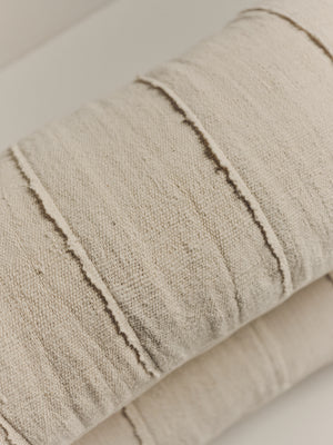 Handwoven white textured cushion — detail view