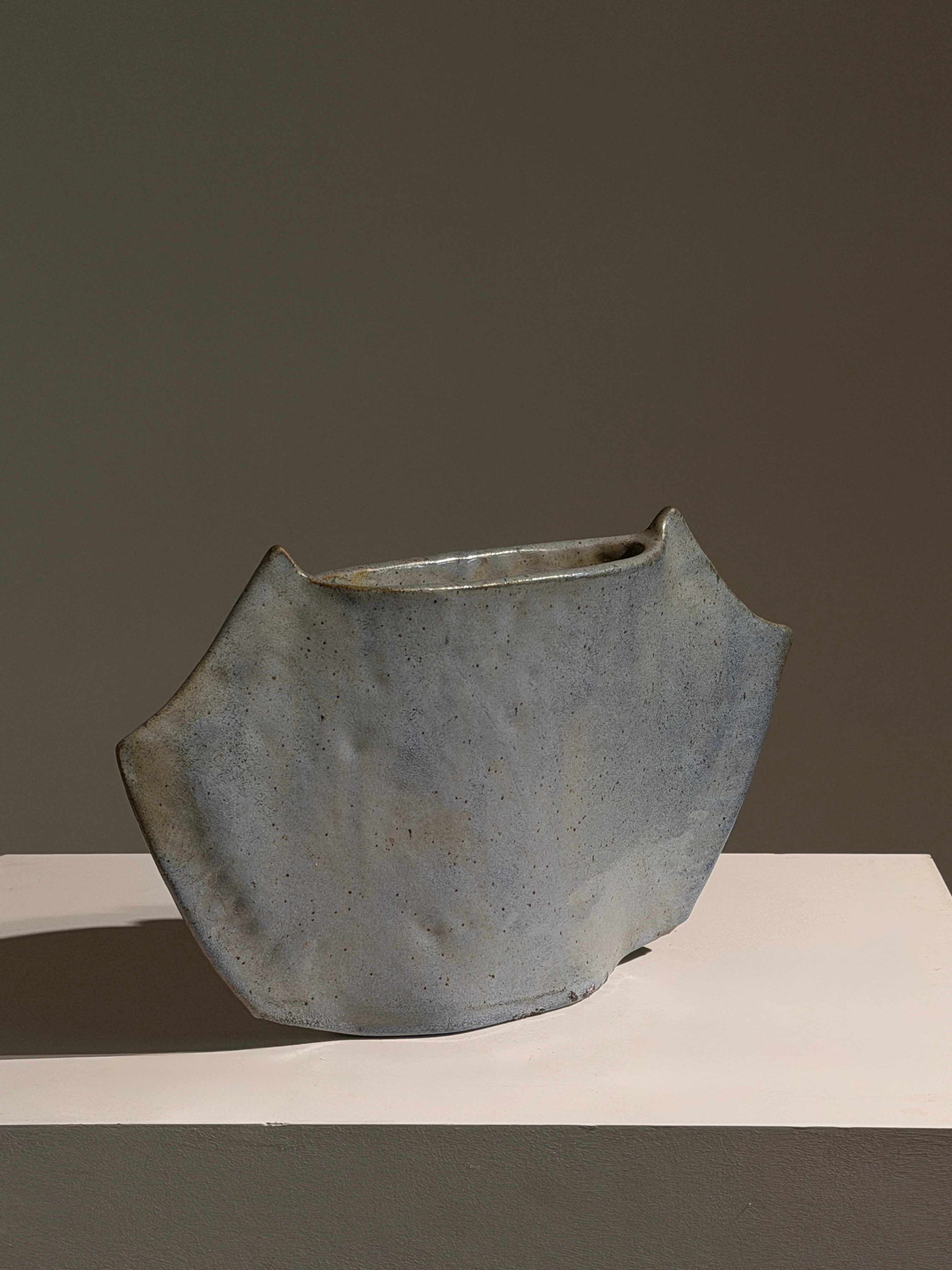 Free-form vase in blue-grey glazed ceramic, France, circa 1970.  — side angle