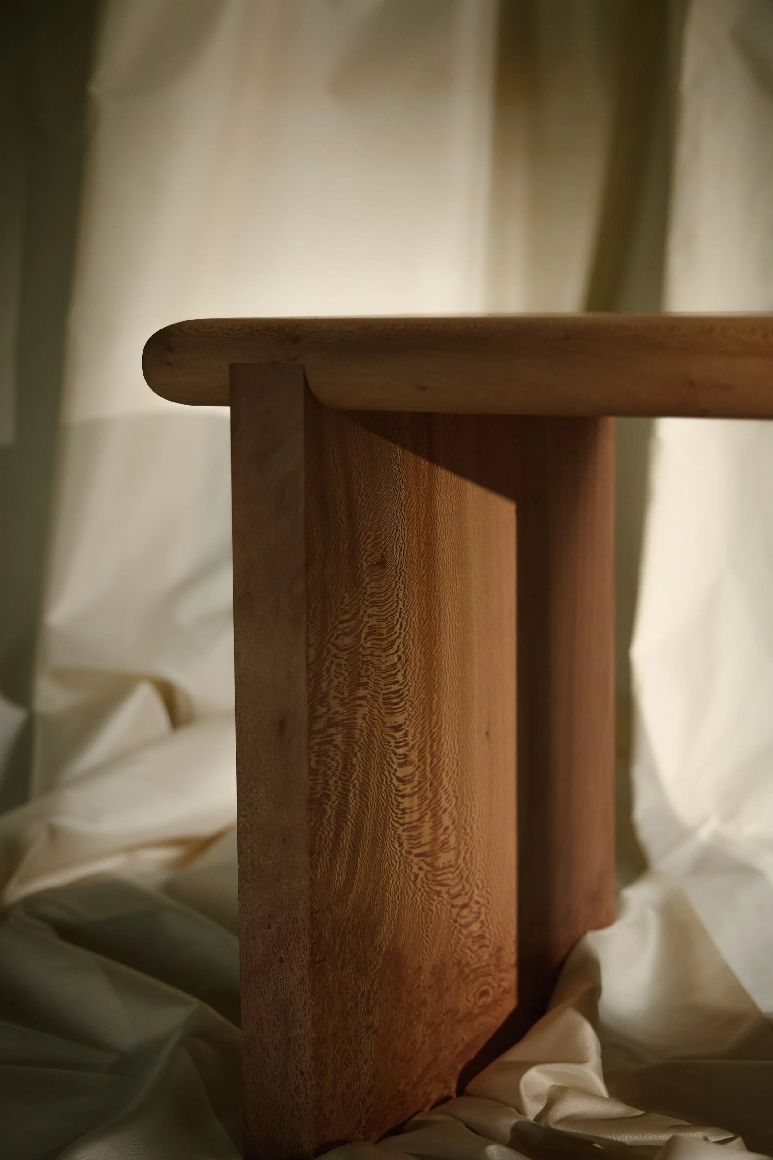The Ferro Side Table — side angle showing natural wood grain detail