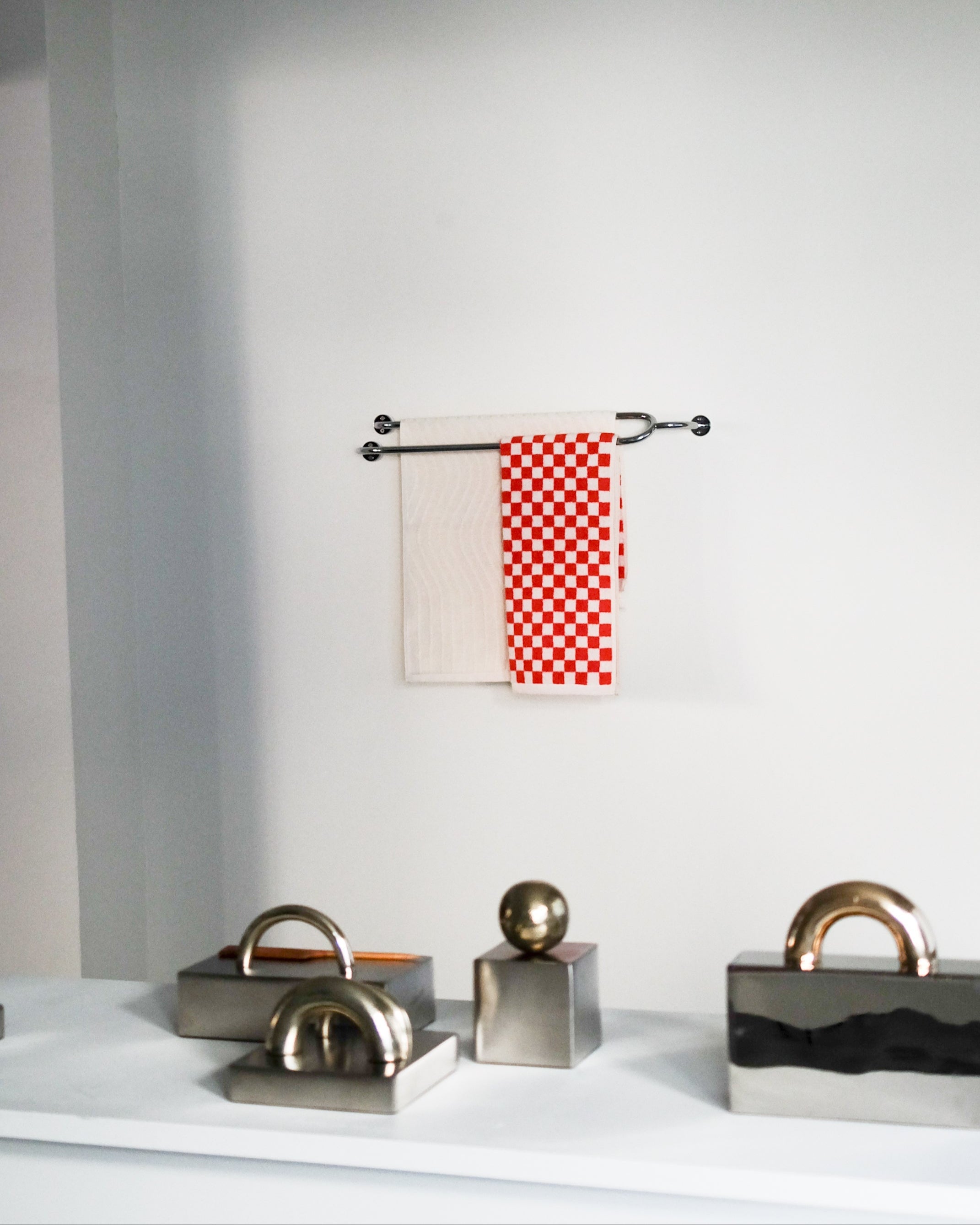FAUNA Towel Bar Double — mounted on wall with red checkered towel