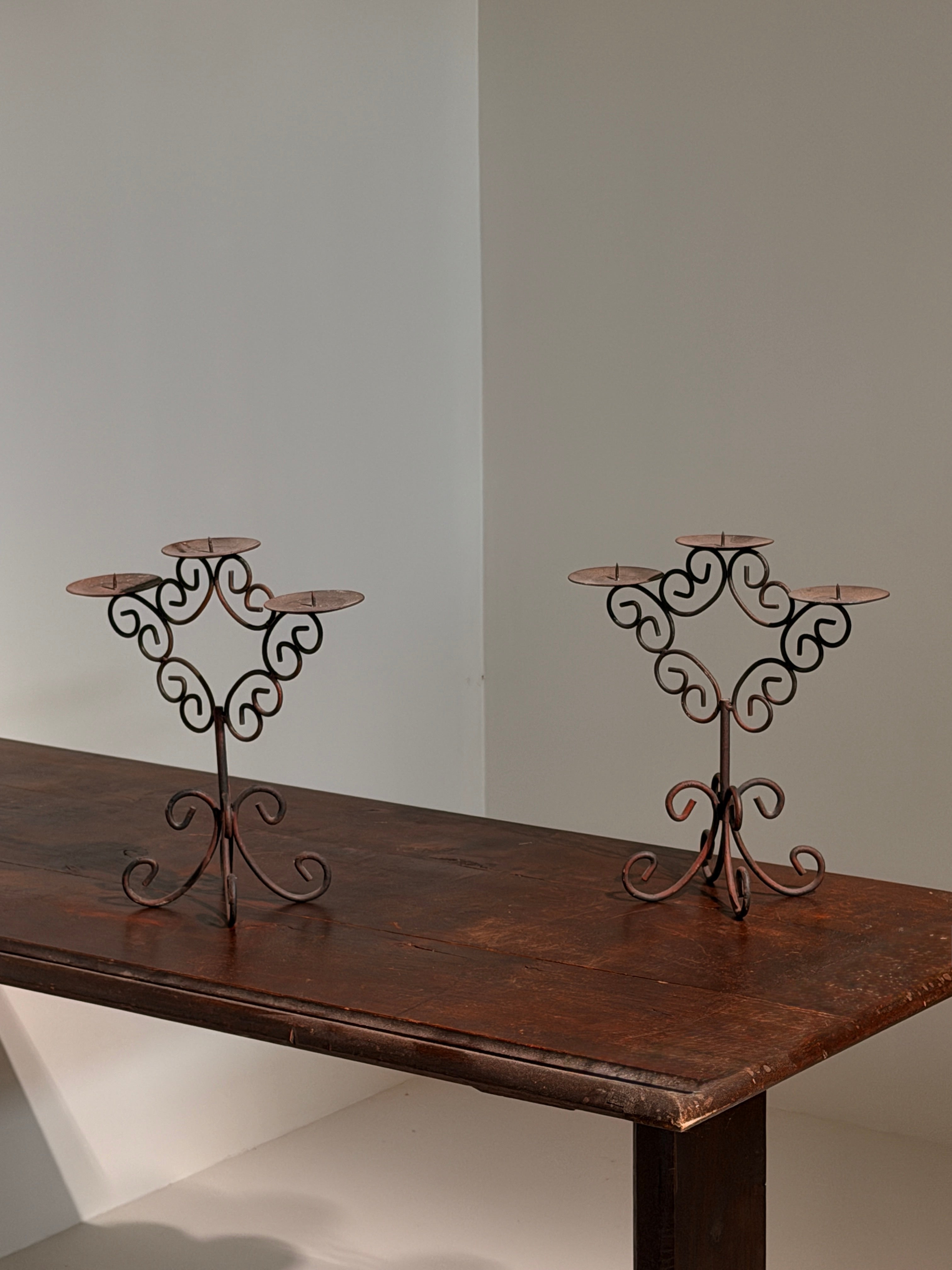 Pair of three-light wrought-iron candleholders, circa 1950 — lifestyle setting