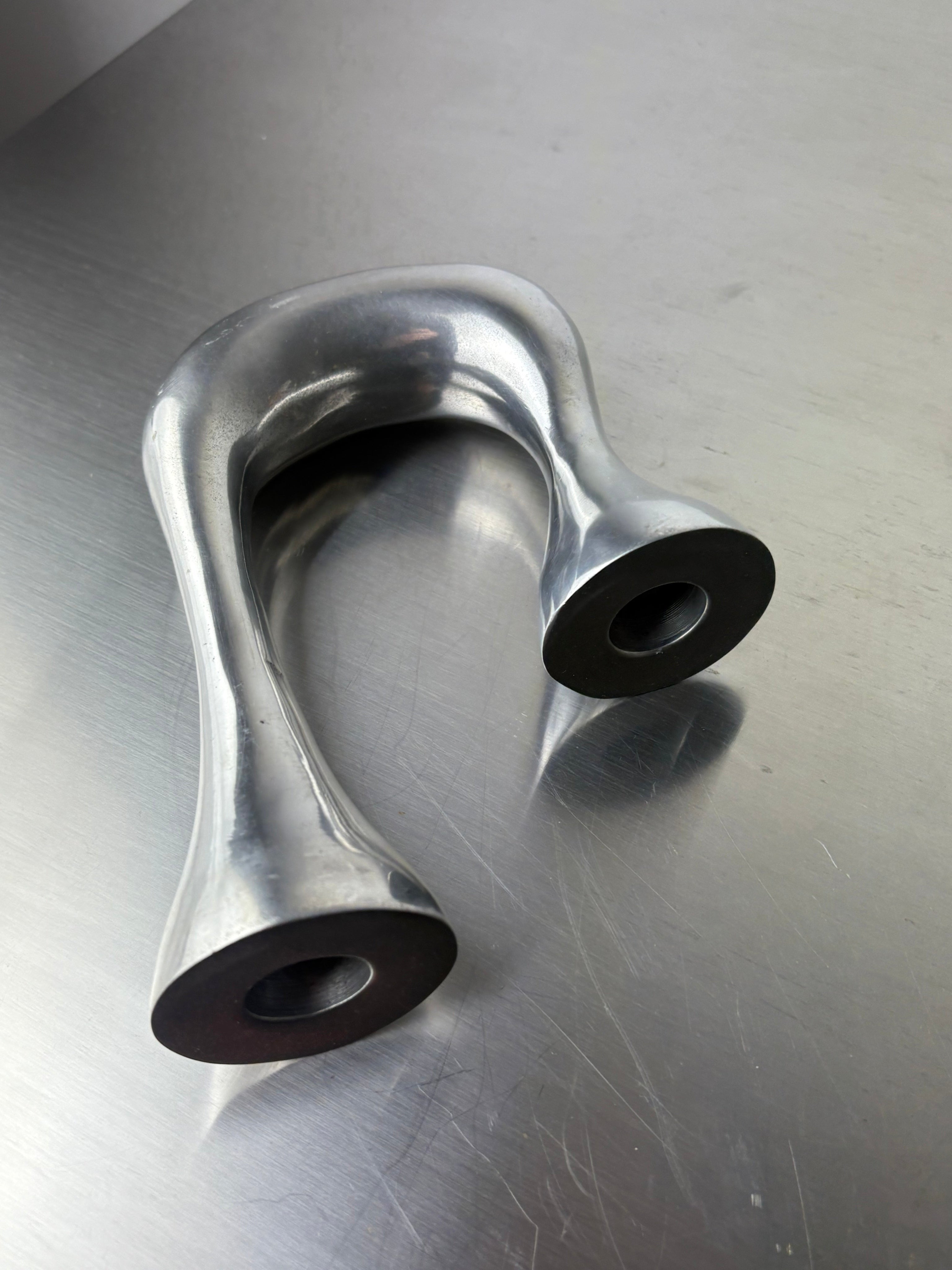 Biomorphic Candleholder, Aluminum, Spain, Circa 1970s — angled view on stainless steel surface