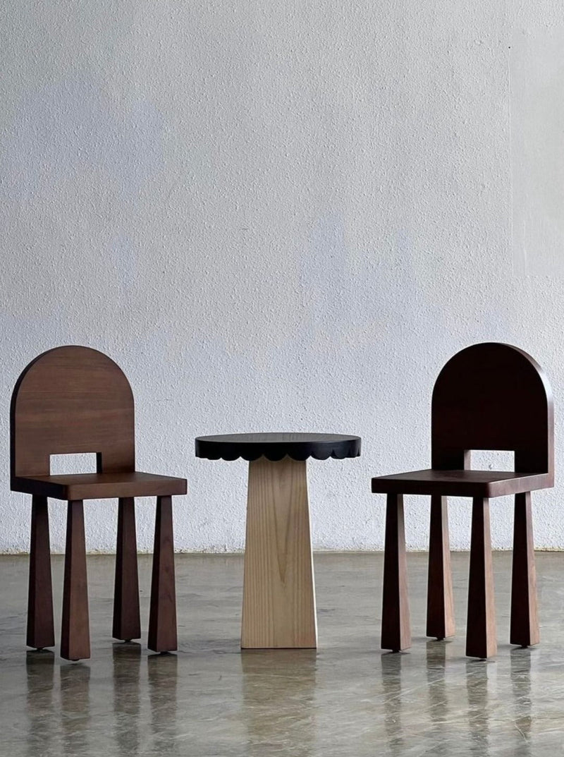 Luna Chair II — front view with dark wood finish and round table