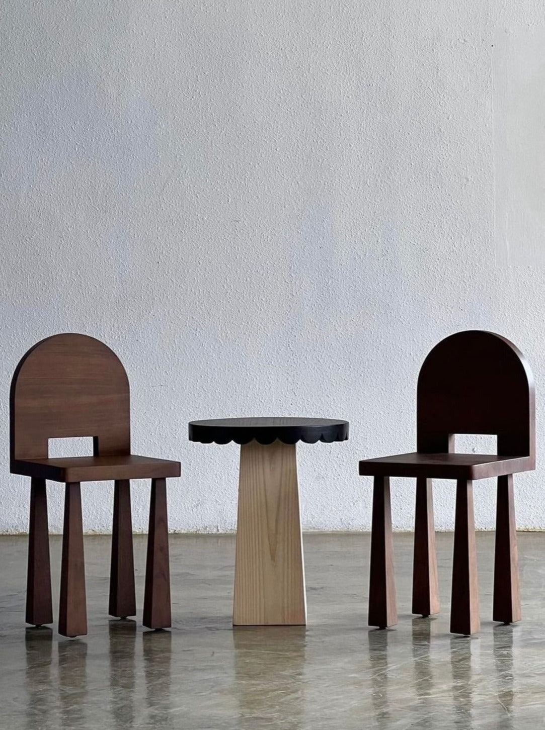 Luna Chair II — front view with dark wood finish and round table