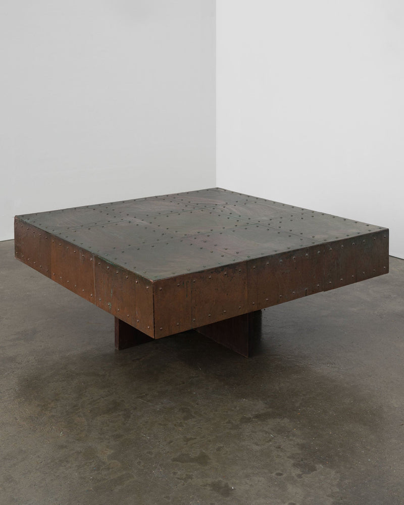 Brutalist copper coffee table with riveted surface and cross base
